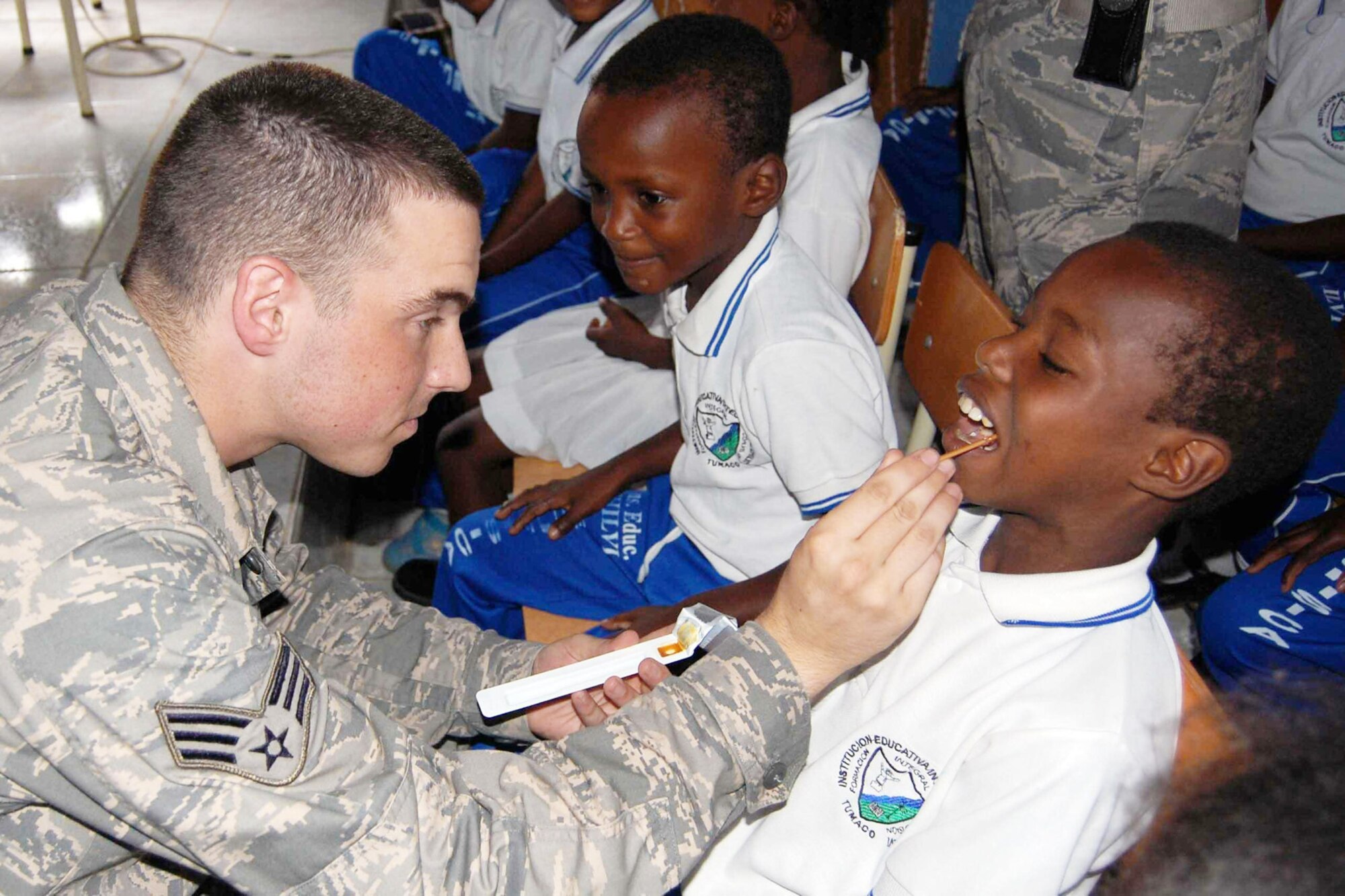 Senior Airman Brett Manz, dental technician aboard Military Sealift Command hospital ship USNS Comfort applies fluoride varnish to a student's teeth to make the them stronger and more resistant to cavities here June 15, 2009 in support of Continuing Promise 2009. CP09 is a four month humanitarian and civic assistance mission to seven countries in Latin America and the Caribbean. Comfort is scheduled to be in Colombia until June 17. (Department of Defense photo/Airman 1st Class Ashley Garcia)