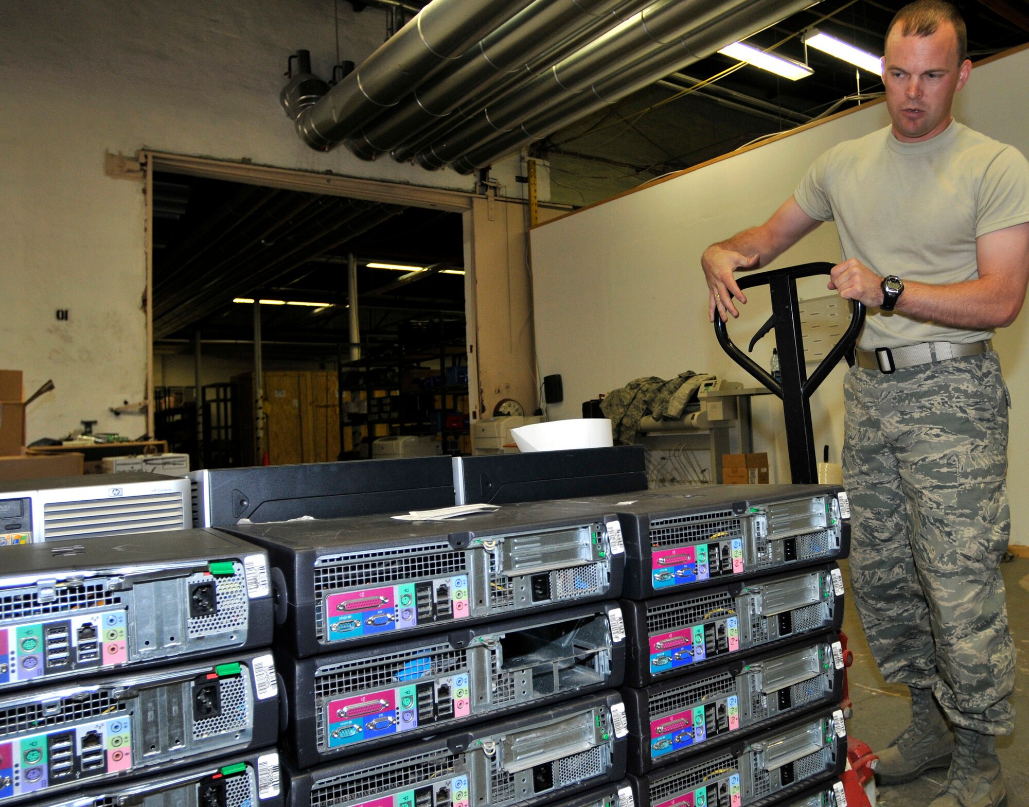 Senior Airmen Eric Talburt, a land mobile radio technician, disassembles computer hardware June 8 at Ramstein Air Base, Germany. The Air Force reservist, assigned to the Air Force Reserve's 302nd Communications Flight at Peterson Air Force Base, Colo., is one of 20 Airmen performing two weeks of annual tour duty in support of Ramstein's communication mission. Many active duty Airmen in the communications career field at the air base have been forward deployed to Iraq and Afghanistan in support Operations Iraqi and Enduring Freedom. (U.S. Air Force photo/Staff Sgt. Stephen J. Otero)