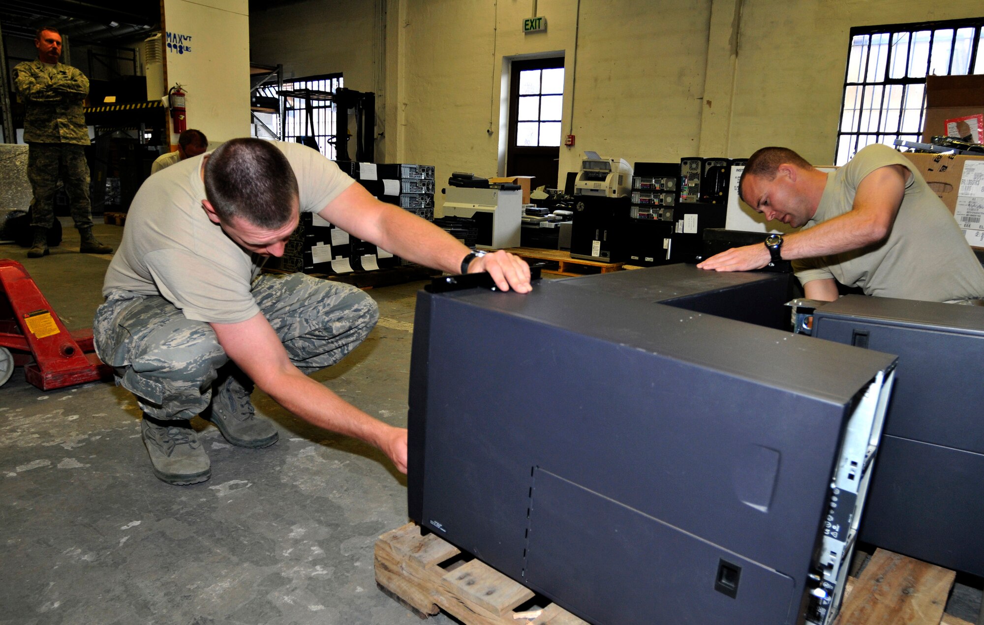 Senior Airmen Jesse Turner (left) and Eric Talburt, land mobile radio technicians,  disassemble computer hardware June 8 at Ramstein Air Base, Germany. Both Air Force reservists, assigned to the Air Force Reserve's 302nd Communications Flight at Peterson Air Force Base, Colo., are performing two weeks of annual tour duty in support of Ramstein's communication mission. Many active duty Airmen in the communications career field at the air base have been forward deployed to Iraq and Afghanistan in support Operations Iraqi and Enduring Freedom. (U.S. Air Force photo/Staff Sgt. Stephen J. Otero)