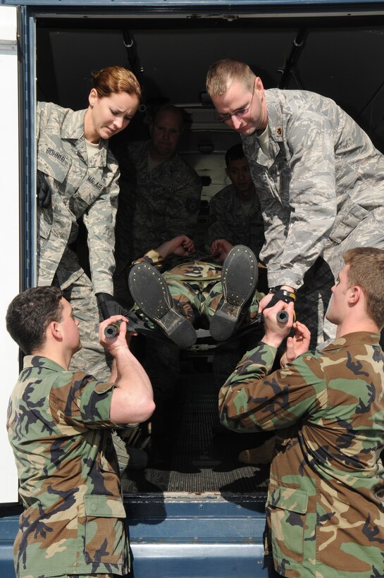 U.S. Air Force Academy, Colo., cadets unload a mock patient during litter training conducted by 435th Contingency Aeromedical Staging Facility personnel, Ramstein Air Base, Germany, June 16, 2009.  The cadets are participating in Operation Air Force, a summer program which provides exposure to real-world Air Force base environments and prepares the cadets for the transition from academy life to active duty.  (U.S. Air Force photo by Staff Sgt. Chenzira Mallory) 