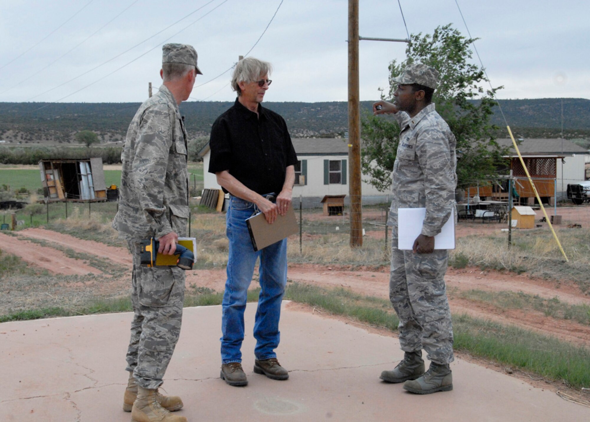 Lt. Col. Thomas Niichel and 2nd Lt. Rexford Cannady of the 240th Civil Engineer Squadron, speak with James Connor, education director for St. Michael?s School June 8, 2009. The three are discussing ideas for the revamping of the five-acre complex near Window Rock, Az. Association for Special Education.