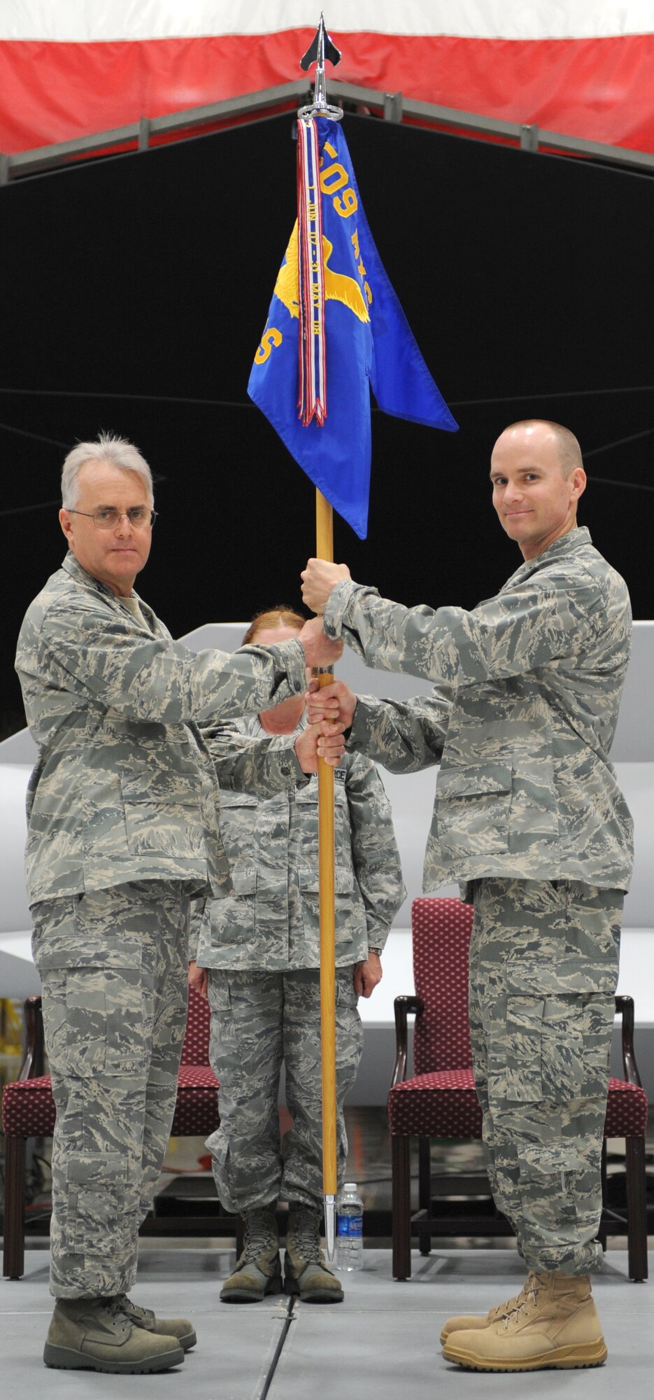 WHITEMAN AIR FORCE BASE, Mo. - Lt. Col. Matthew Snyder receives Maintenance Operations Squadron Guidon form Col. James Reavis, 509th Maintenance Group commander, June 12 during the 509th MOS Change-of-Command ceremony. Colonel Snyder relieved Maj. Mark Riselli during the ceremony.