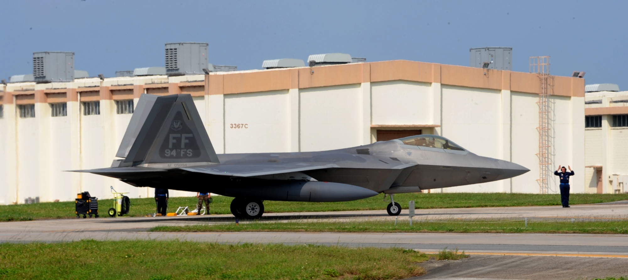 KADENA AIR BASE, Japan - Senior Airman Jonathan Spencer, 192nd Fighter Wing crew chief, marshals in Lt. Col. Adrian Spain, 94th Fighter Squadron commander.  This was the first deployment of the 94th FS since transitioning to the F-22A Raptor.  The 94th FS flagship was the first Raptor to touch down at Kadena Air Base, Japan May 30.  (U.S. Air Force photo/Airman 1st Class Jarrod Chavana) 
