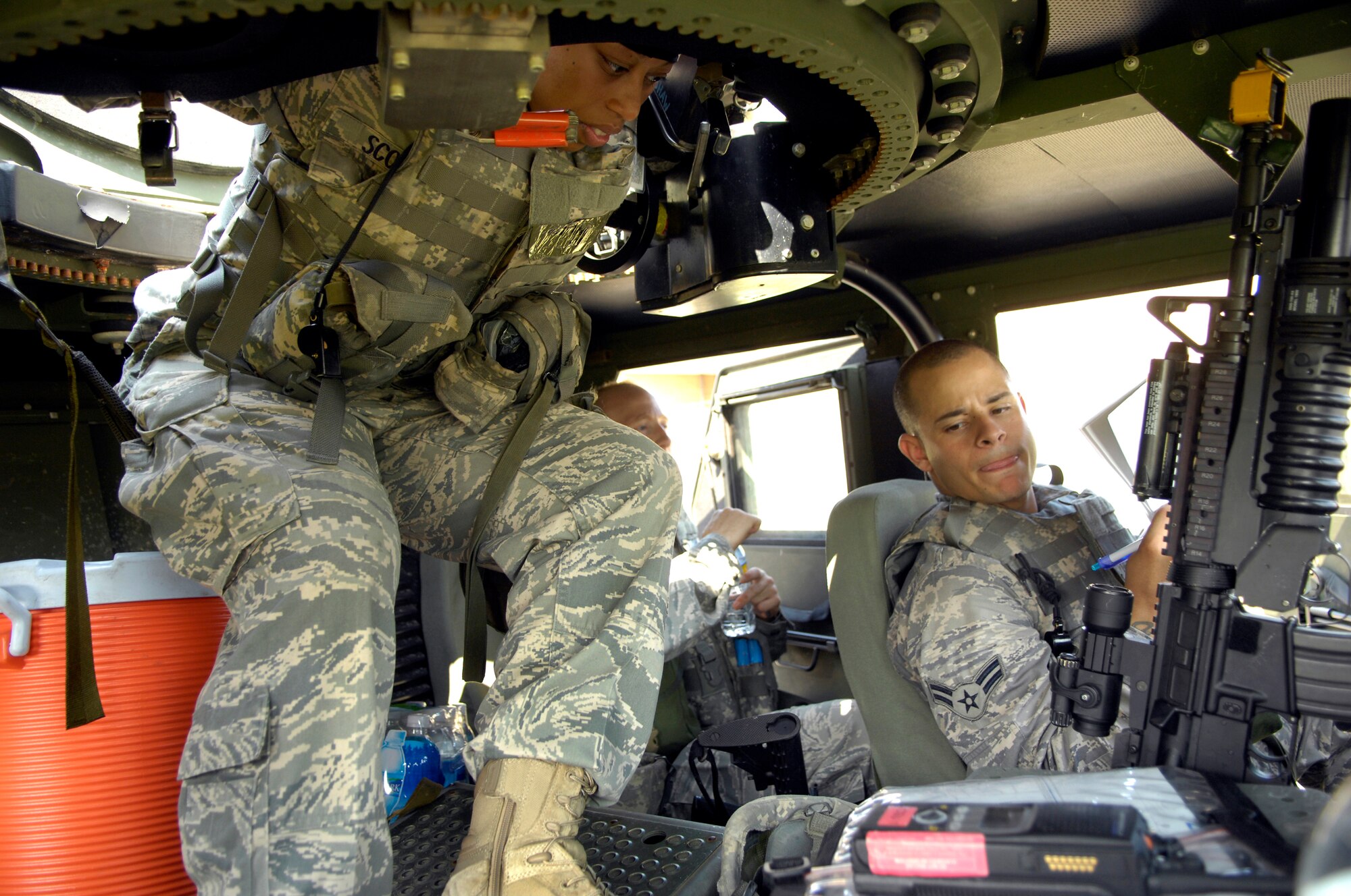 SHAW AIR FORCE BASE, S.C. -- 20th Security Forces Squadron personnel, Airmen 1st Class Ashley Scott, left, and Daniel Alicea, discuss a vehicle checklist before a convoy movement to a simulated cantonment area for Team Shaw's operational readiness inspection, June 15. The ORI will evaluate Shaw's ability to survive and operate in combat conditions. (U.S. Air Force photo/Senior Airman Kathrine McDowell)