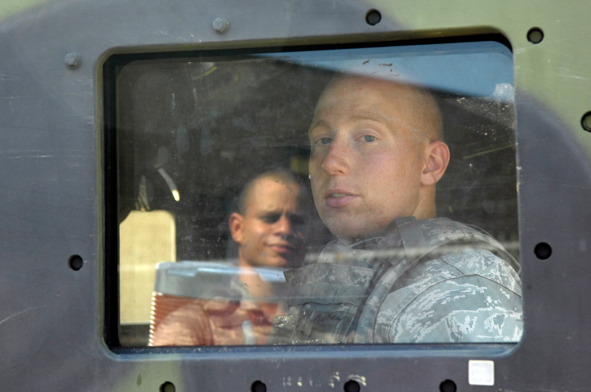 SHAW AIR FORCE BASE, S.C. -- 20th Security Forces Squadron personnel, Airmen 1st Class Matthew Nitsch, right, and Daniel Alicea, wait for the order to move before a convoy movement to a simulated cantonment area for Team Shaw's operational readiness inspection, June 15. The ORI will evaluate Shaw's ability to survive and operate in combat conditions. (U.S. Air Force photo/Senior Airman Kathrine McDowell)