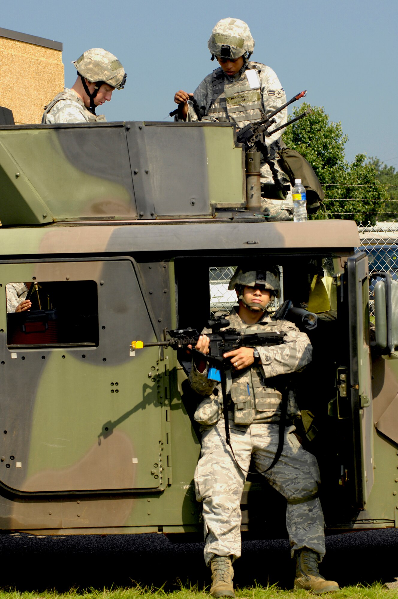SHAW AIR FORCE BASE, S.C. -- 20th Security Forces Squadron members, Airmen 1st Class Daniel Alicea, bottom, Matthew Nitsch, left, and Ashley Scott, prepare for a convoy movement to a simulated cantonment area for Team Shaw's operational readiness inspection, June 15. The ORI will evaluate Shaw's ability to survive and operate in combat conditions. (U.S. Air Force photo/Senior Airman Kathrine McDowell)