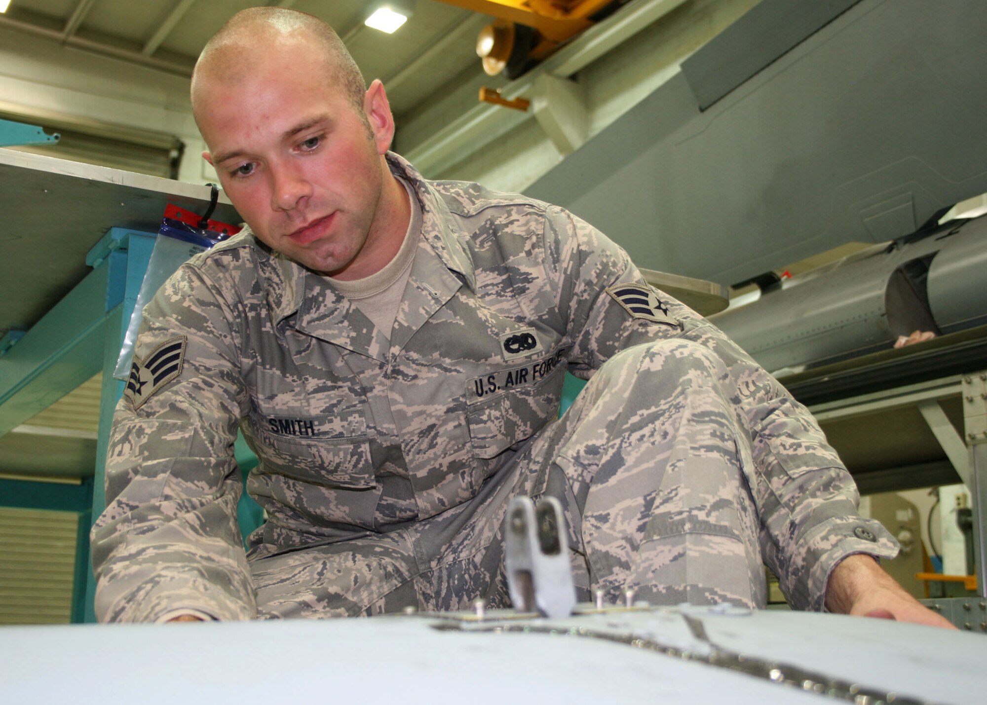SPANGDAHLEM AIR BASE, Germany – Senior Airman Bryan Smith, 52nd Equipment Maintenance Squadron, assesses the weight of an A-10 rudder June 9. The evaluation must be performed because it is essential that flight controls are balanced. (U.S. Air Force photo by Airman 1st Class Nicholas Wilson)