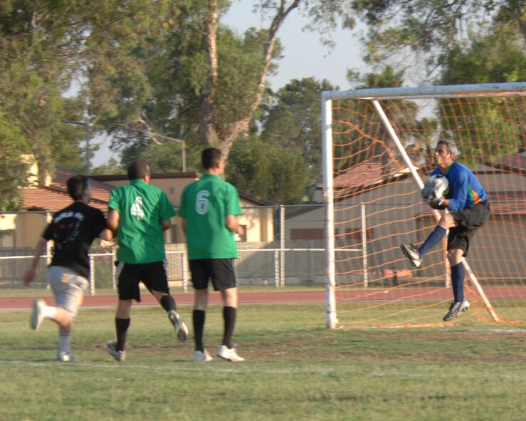 Recep Tekin, 39th Civil Engineering Squadron goalie, prevents a goal during the intramural base soccer finals, Monday, June 15, 2009, Incirlik Air Base, Turkey. The game ended in a shootout between the two teams, with the CES scoring 3-of- 4 kicks to the OS 2-of- 5 kicks. The finals consist of a double elimination tournament, therefore, the two squadrons will play again Tuesday, June 16, 2009 to determine the winner. (U.S. Air Force photo/Staff Sgt. Lauren Padden). 
