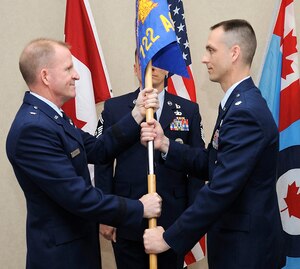 LANGLEY AIR FORCE BASE, Va. – Lt. Col. DeWayne A. Nikkila assumes command of the 722d Air Control Squadron by accepting the guidon from Brig. Gen. Stephen W. Wilson, Canadian North American Aerospace Defense Region deputy commander, during the change of command ceremony in Ontario, Canada June 11.  Lieutenant Colonel Nikkila assumed command from Lt. Col. David D. Johnson.  (U.S. Air Force courtesy photo)