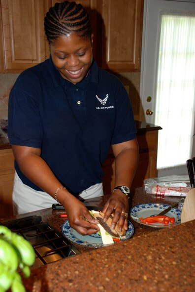 Staff Sgt. Nyeisha Coar makes a turkey sandwich, complete with Hellman's Mayonnaise, for her boss, Air Force District of Washington Commander Maj. Gen. Ralph Jodice. Sergeant Coar is a personal aide. Her duties include maintaining the general's uniforms; arranging official social events; preparing meals, to include menu planning and shopping; performing administrative duties and record keeping; maintaining the living quarters, to include daily routine tasks and seasonal requirements; and performing tasks that aid the general in accomplishing his military and official responsibilities. (Air Force photo by Benjamin Newell) 
