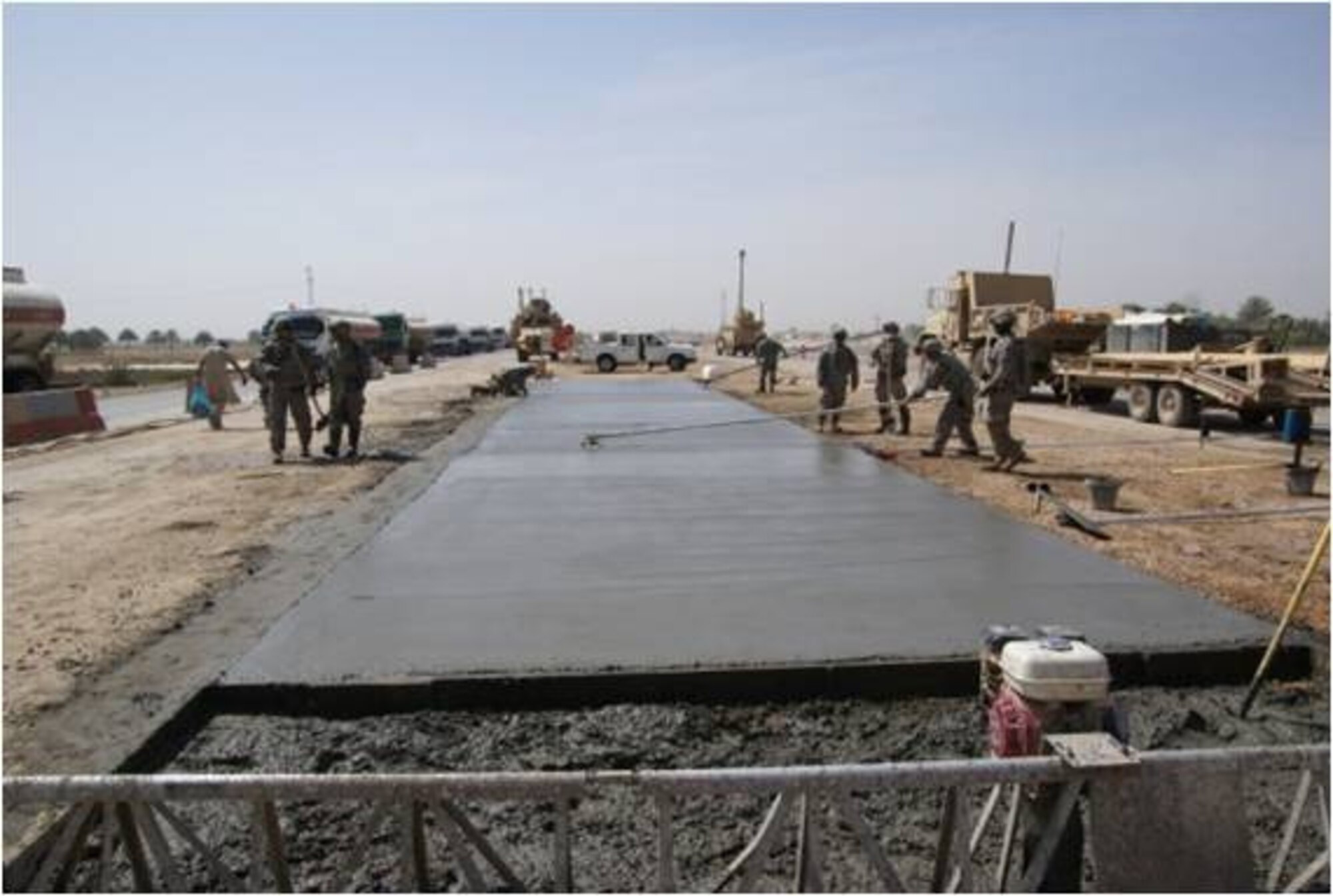Airmen from the 732nd Expeditionary Civil Engineer Squadron, Detachment 3, partnered with the Army 180th Engineer Company for the construct of the high profile Scania Highway by-pass project in Scania, Iraq April 21, 2009.  The Airmen spent 29 days outside the wire in full body armor and constructed a reinforced concrete pad using 104 cubic meters of concrete to ensure a smooth transition for Coalition convoys and Iraqi civilian traffic entering and exiting the Scania area. The eight kilometer stretch was classified as the number one project for the Multi National Corps in Iraq.  (Courtesy Photo)