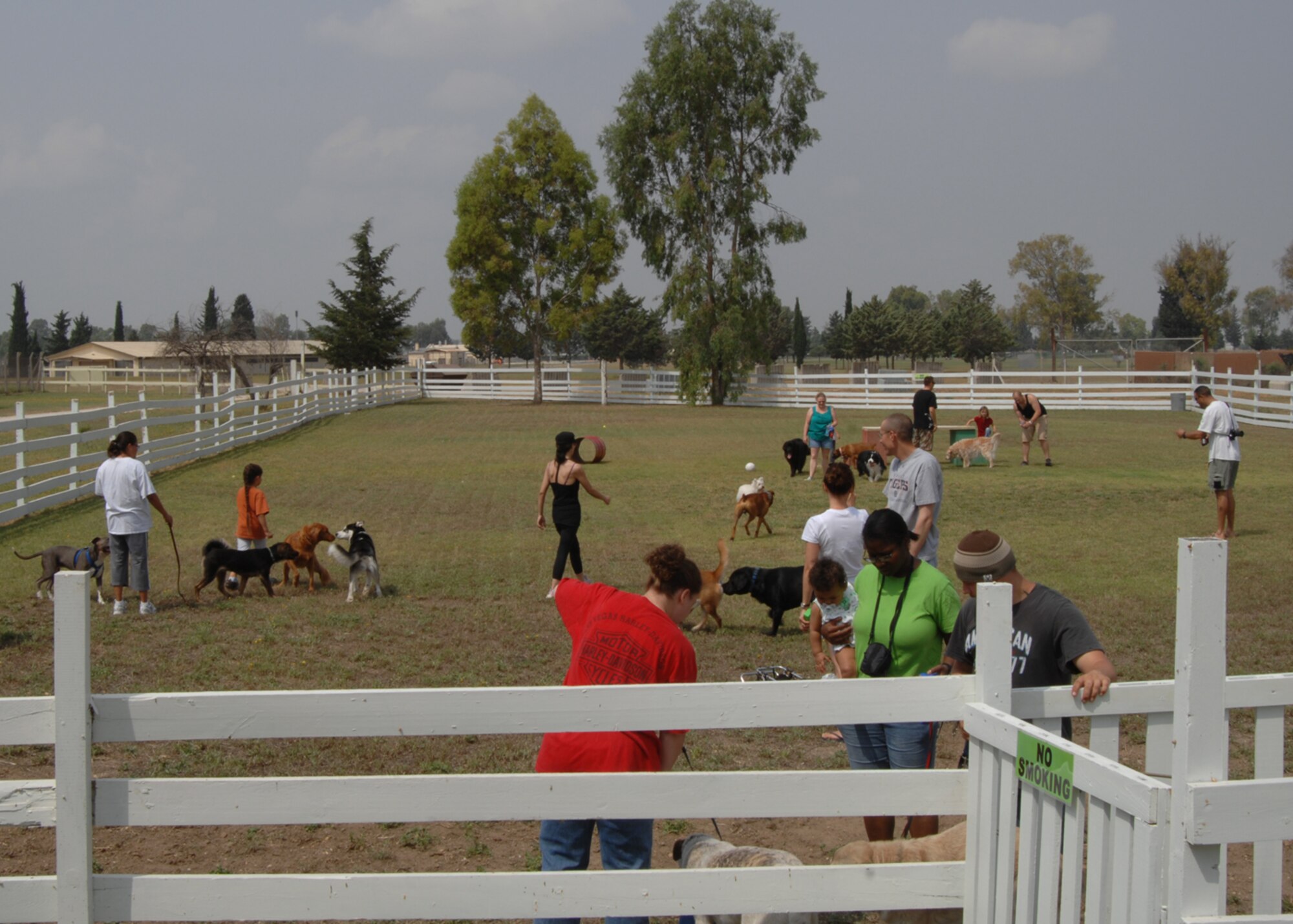 Incirlik families enjoy the new Dog Patch dog park here during its grand opening Saturday, June 13, 2009.  Dog Patch is a private organization run by volunteers to offer a space for all dogs on base to run free in a confined area. The volunteers organized fundraisers, collected donations of materials and worked numerous weekends to make the park people and dog friendly. Park hours are from sunrise to sunset and require all dogs to be supervised by the owner and fully vaccinated. (U.S. Air Force photo/Staff Sgt. Lauren Padden)