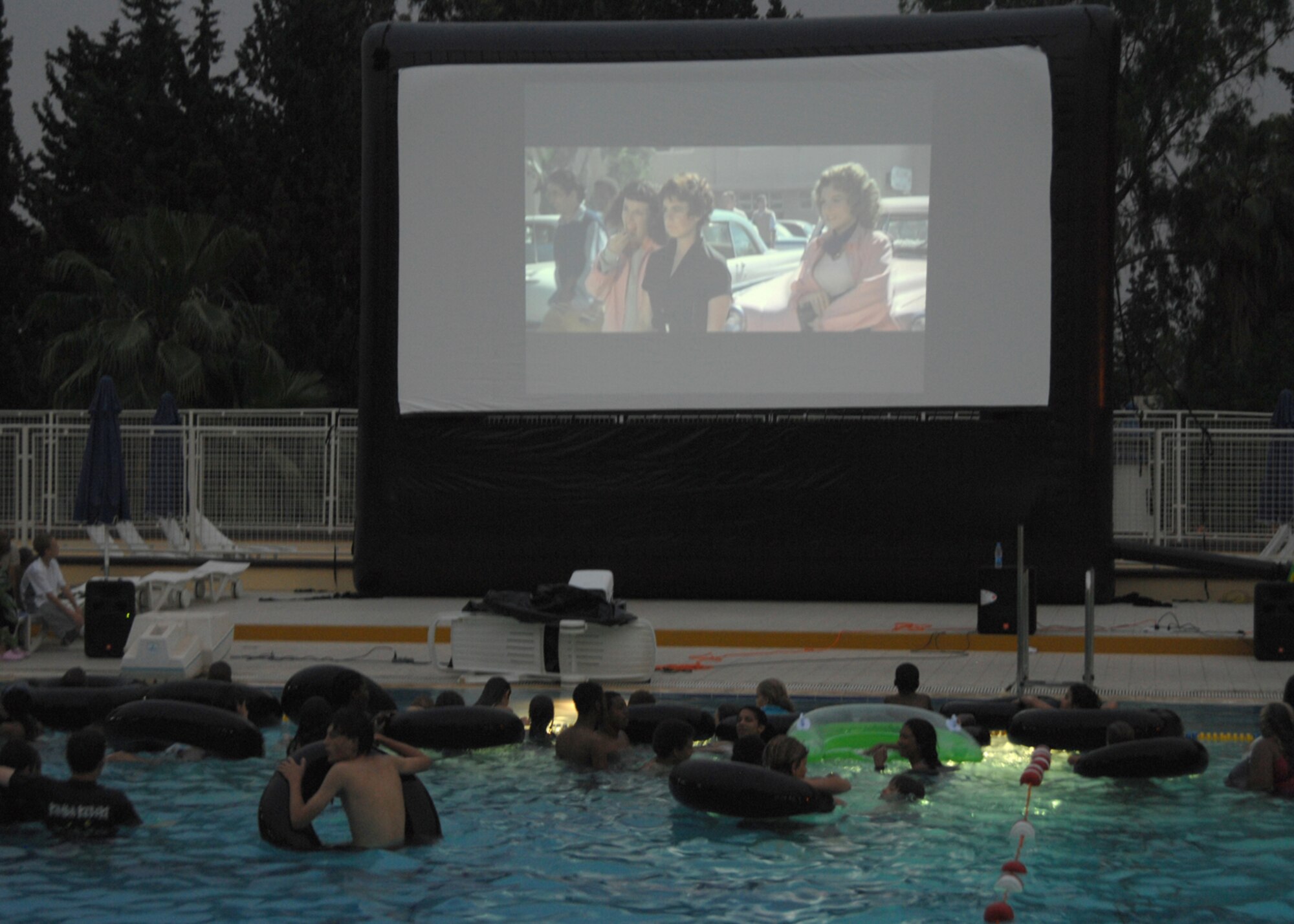 Incirlik Airmen and their families take advantage of a warm summer evening by swimming and watching a movie at the base pool here Thursday, June 11, 2009. The movie “Grease” was featured as part of the Dive-In Movie event hosted by the 39th Force Support Squadron. (U.S. Air Force photo/Staff Sgt. Lauren Padden)