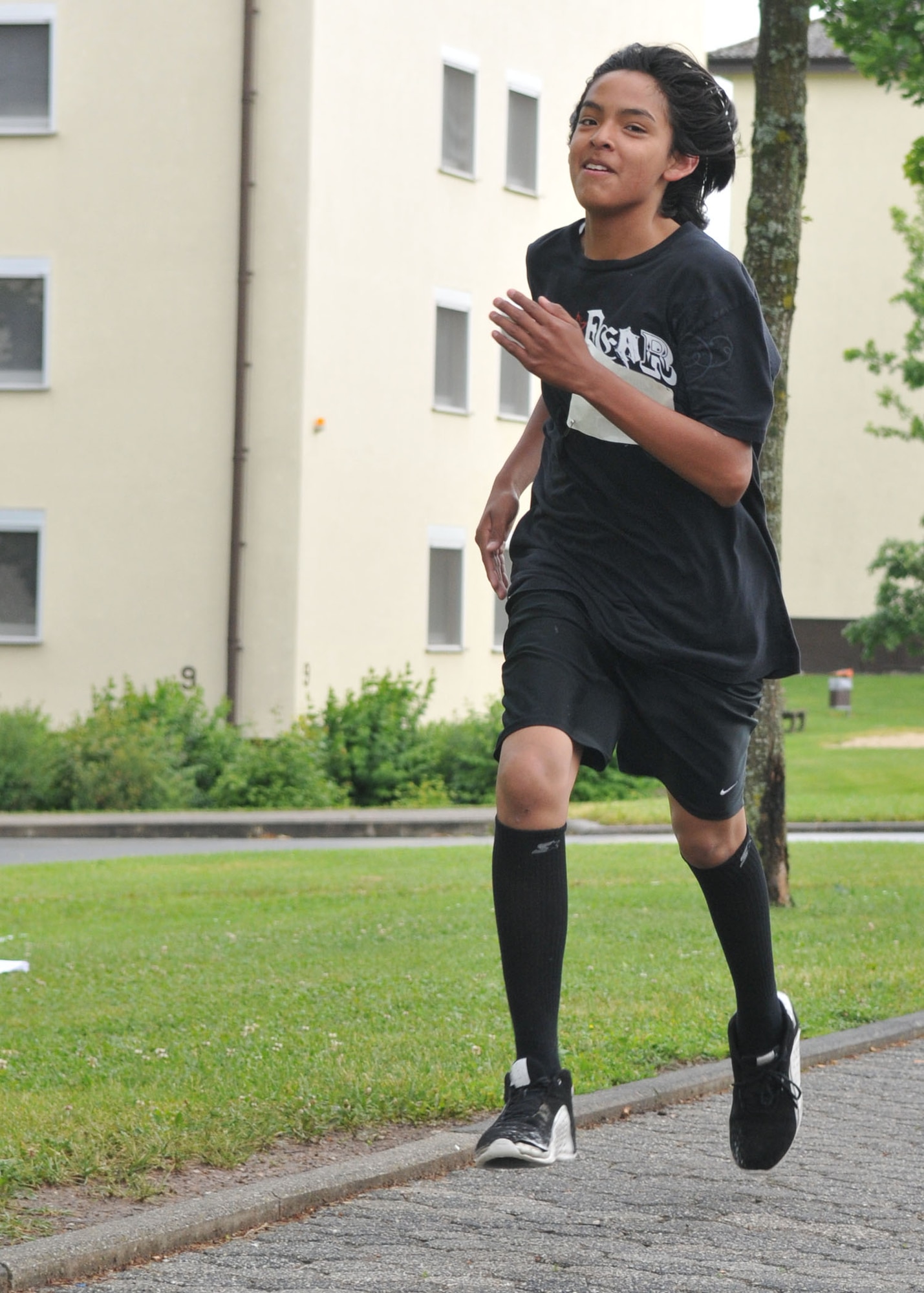 SPANGDAHLEM AIR BASE, Germany -- Ki Jana Martinez, a Bitburg Middle School seventh grader, finishes first in the “Race into Summer” at Bitburg Middle School June 11. Ki Jana finished the race with a time of 6 minutes and 2 seconds. The event was a one mile run to celebrate the end of the school year. (U.S. Air force photo by Airman 1st Class Nick Wilson)