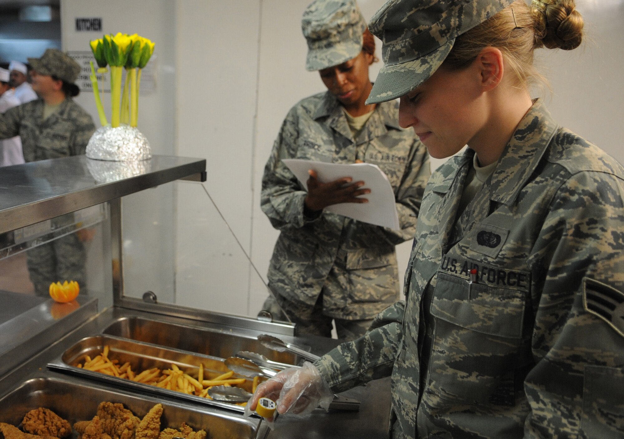 JOINT BASE BALAD, Iraq — Senior Airmen Melissa Grant and Angela Prince, 332nd Expeditionary Force Support Squadron, check and record the temperature of food at DFAC 2 here June 3. Checking the temperature ensures the food is properly cooked and maintained at safe temperatures. Airman Grant is deployed here from Minneapolis- St. Paul Air Reserve Station, Minn., and is a native of Maplewood, Minn. Airman Prince is deployed here from Wright Patterson Air Force Base, Ohio, and is from Detroit. (U.S. Air Force photo/Senior Airman Elizabeth Rissmiller)   
