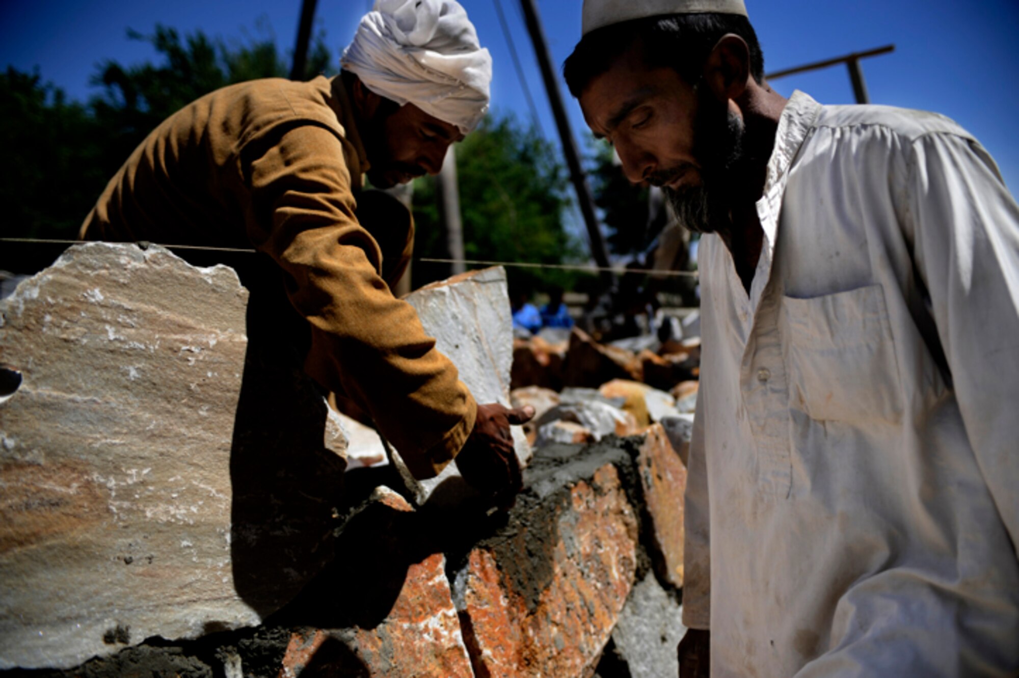 Contract workers from the Rodat district work on the masonry of a well wall May 28, Nangarhar Province, Afghainstan. The project is developed and monitored by the Nangarhar Agri-Business Development Team, Forward Operating Base Finley-Sheilds, Nangarhar, Afghanistan which is responsible for designing projects which will drastically improve the agricultural production of rural farming communities in the province. The team supports the construction of wells, karizes, veterinary clinics and reforestation projects.