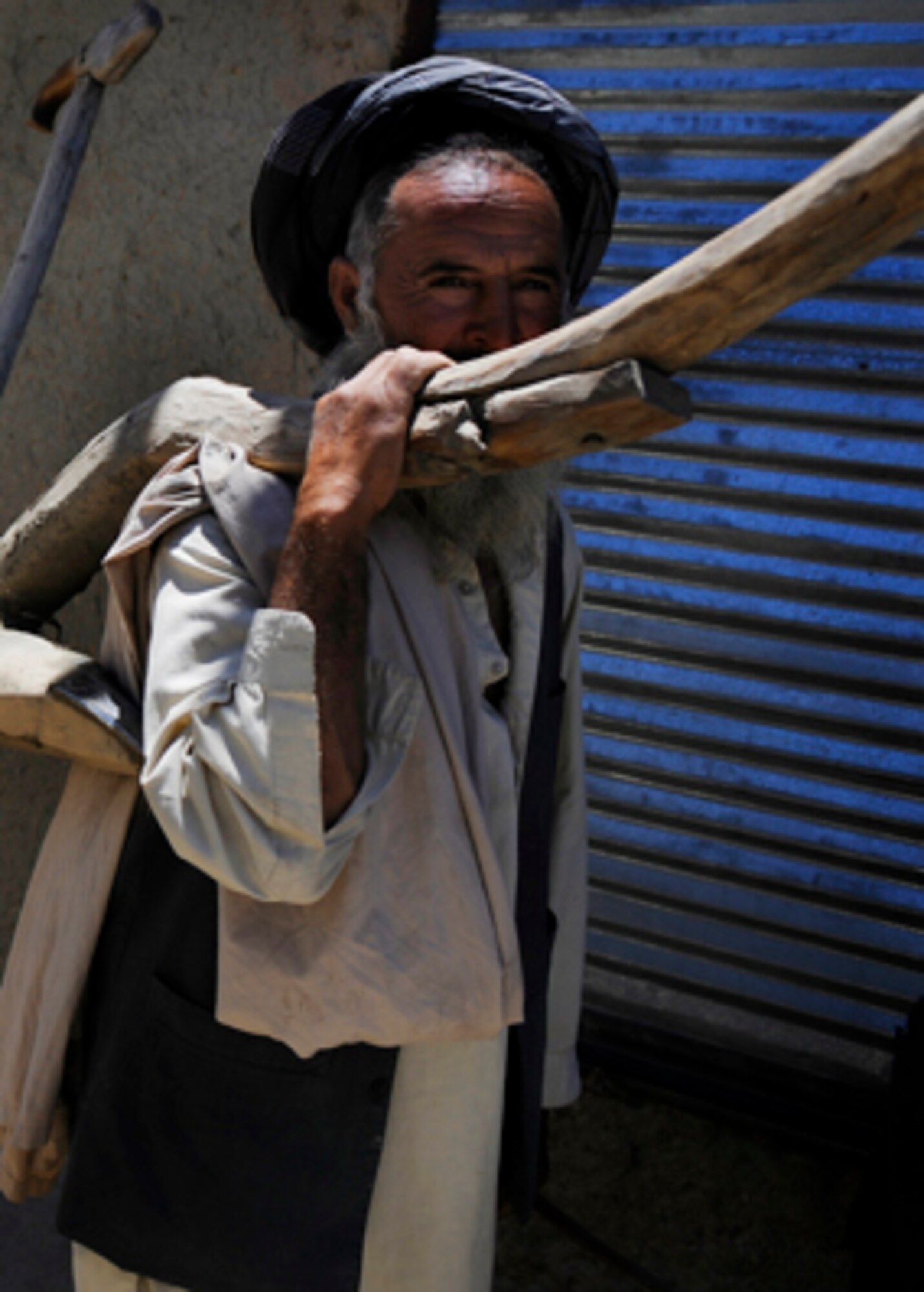 A farmer in the Rodat district carries a handmade plow to the fields to harvest his crops May 28, Nangarhar Province, Afghanistan.
