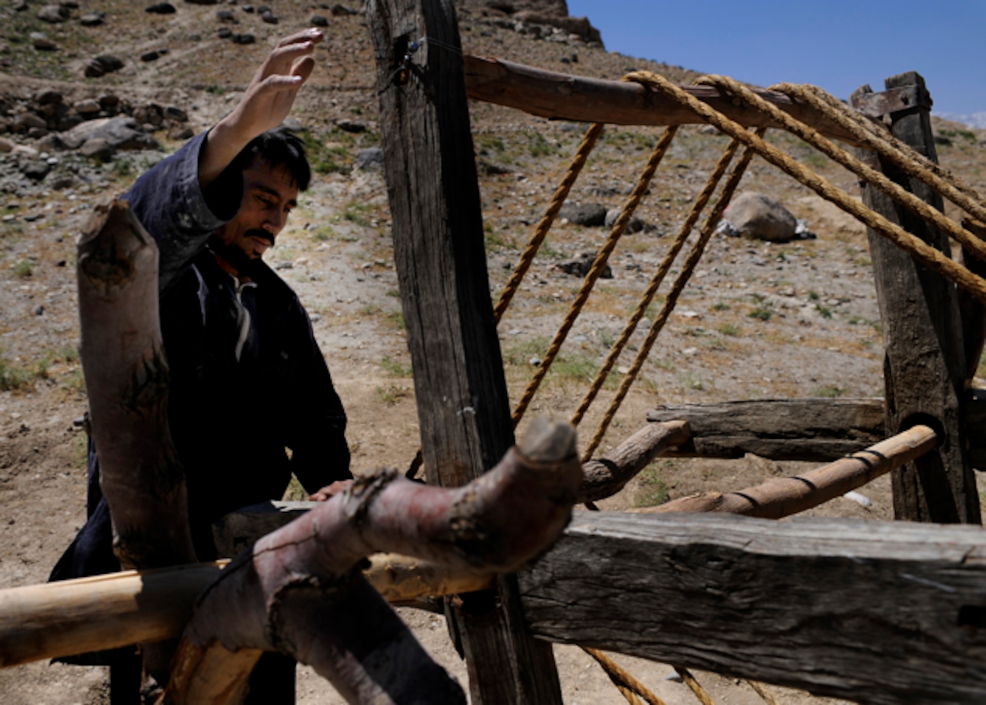 Local Afghans from the Rodat district use a pulley system to transfer dirt from a well site May 28, Afghanistan.The project is developed and monitored by the Nangarhar Agri-Business Development Team which is responsible for designing projects which will drastically improve the agricultural production of rural farming communities in the province. The team supports the construction of wells, karizes, veterinary clinics, and reforestation projects. (U.S. Air Force Photo by Staff Sgt. Shawn Weismiller)