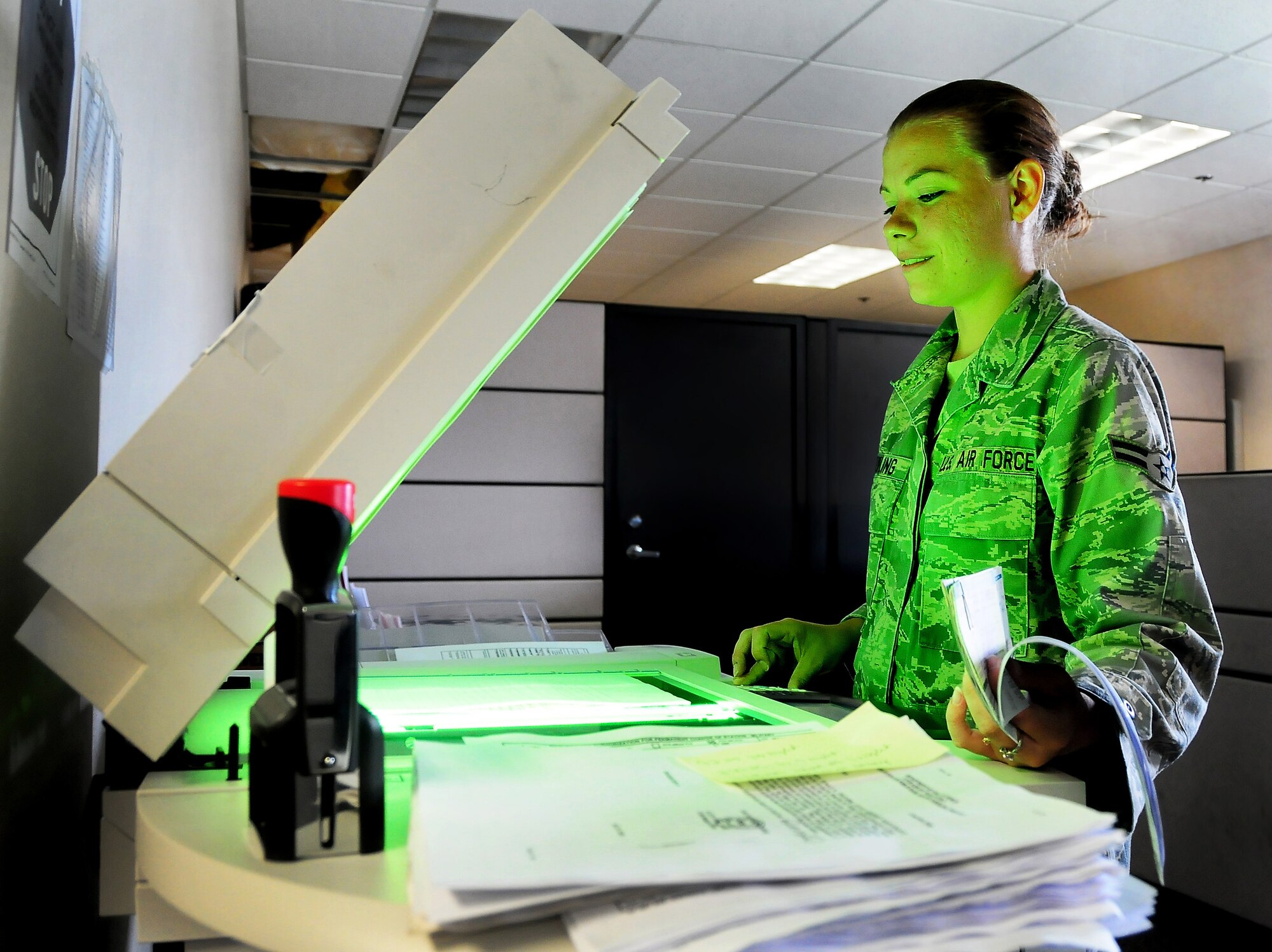 Airman 1st Class Brittney Knowling operates a copy machine at the base finance office here June 17 to create digital and paper duplicates of checks received from the base Education and Training Center. The finance office keeps accurate records of all base funds and files receipts for a period of six years and three months. Airman Knowling is a customer service technician with the 437th Comptroller Squadron. (U.S. Air Force photo/Staff Sgt. Daniel Bowles)
