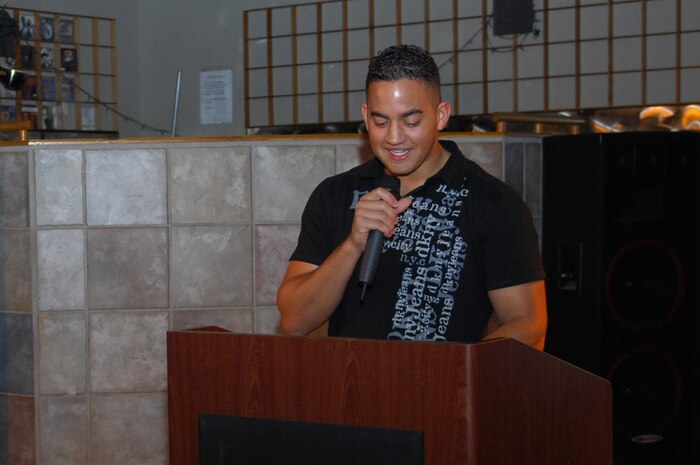 NELLIS AIR FORCE BASE, Nev. -- Airman 1st Class Christopher Camm, from the 99th Communications Squadron, reads a poem he wrote during the African American Cultural Association (AACA) sponsored Open Mic Night here, June 16.  The AACA Open Mic Night is to open to all every third Tuesday of the month from 7 to 9 p.m. at the Desert Oasis Enlisted Club. (U.S. Air Force photo by Staff Sgt. Taylor Worley
