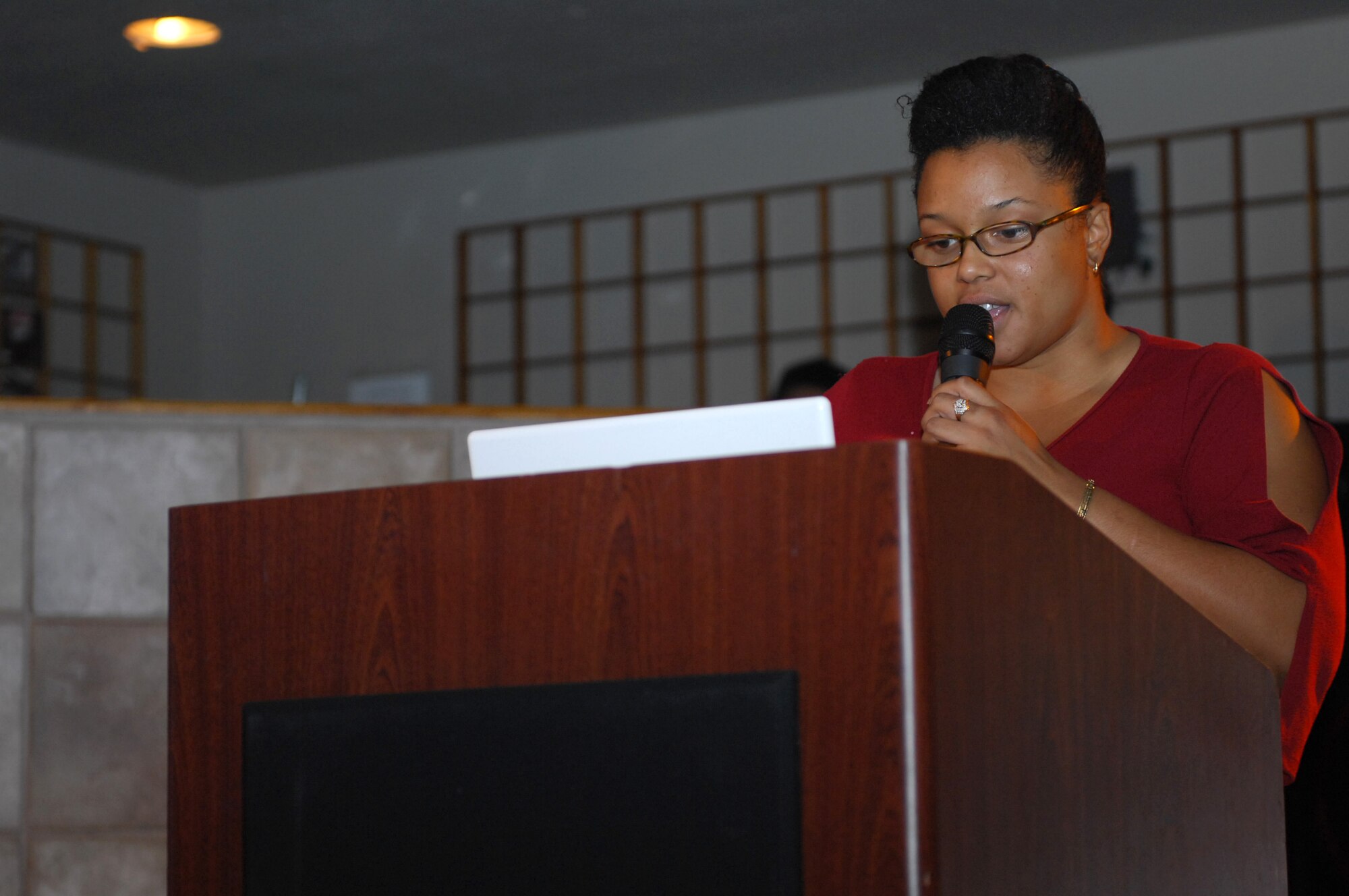 NELLIS AIR FORCE BASE, Nev. -- Ms. Stephanie Rose, sister of Cpl. Jonathon Rose, reads a poem she wrote during the African American Cultural Association (AACA) sponsored Open Mic Night here, June 16.  The AACA Open Mic Night is open to all and held every third Tuesday of the month from 7 to 9 p.m. at the Desert Oasis Enlisted Club. (U.S. Air Force photo by Staff Sgt. Taylor Worley)