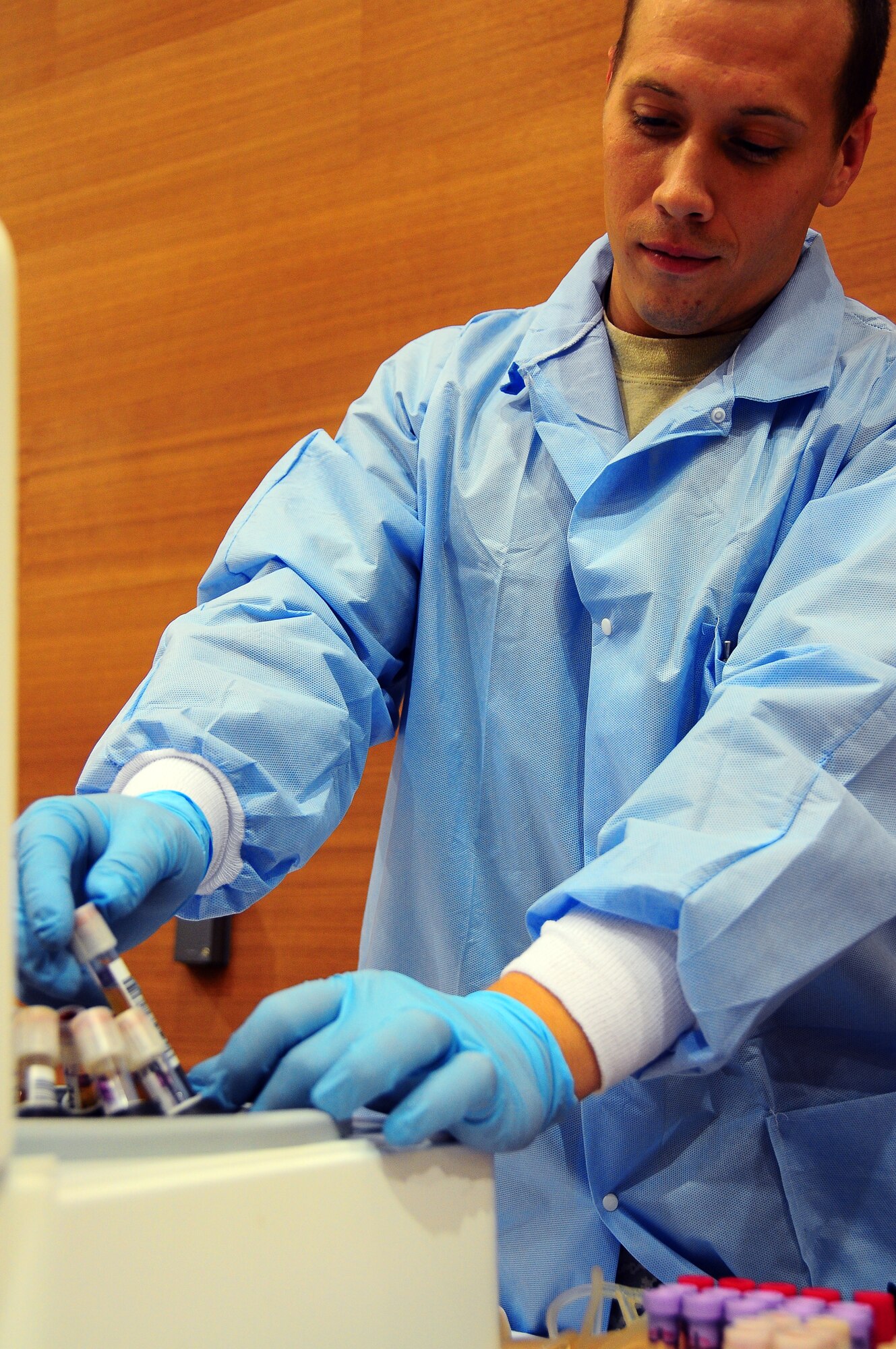 YOKOTA AIR BASE, Japan -- Staff Sgt. David Bates, medical laboratory technician, removes samples from the centerfuge June 16 as part of three day Armed Services Blood Bank drive.  The centerfuge spins the samples to seperate the plasma from the red cells. Sergeant Bates is part of the team that traveled from Camp Lester in Okinawa, Japan to collect blood from the Yokota Air Base community.  (U.S. Air Force Photo/Tech. Sgt. Kimberly Spinner)