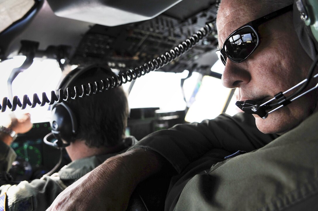 Lt. Col. Mark Stevens looks out over the horizon during a training mission flight June 7 over the Caribbean from St. Croix, V.I. The Hurricane Hunters of the 53rd Weather Reconnaissance Squadron conducts part of their training from their operations center in St. Croix at the start of the active season which began June 1. Colonel Stevens is a navigator with the squadron.  (U.S. Air Force photo/Staff Sgt. Desiree Palacios)