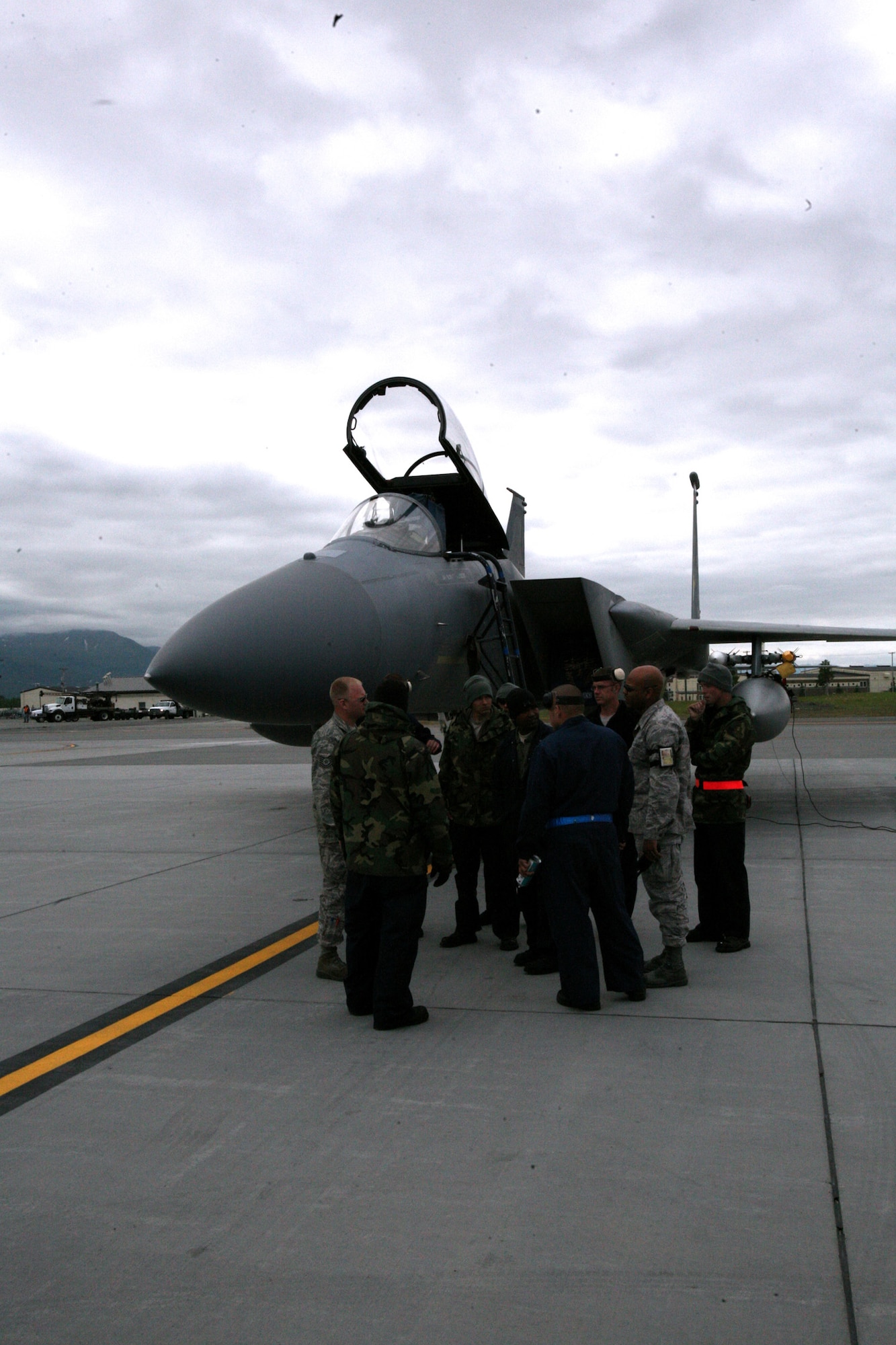 Air Force mechanics with the 44th Aircraft Maintenance Unit out of Kadena, Japan, discuss the morning tasks for an F-15C Eagle preflight inspection June 16 at Elmendorf Air Force Base, Alaska (Photo by Sgt. Ricardo Branch, 8th Theater Sustainment Command Public Affairs).