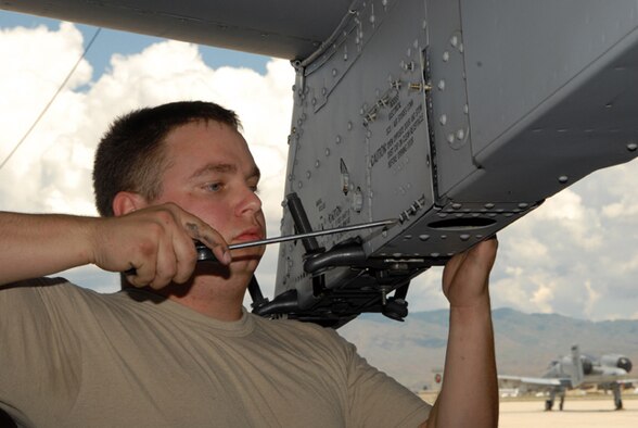 Idaho Air National Guard avionics technician Senior Airman Dustin Martin, 124th Aircraft Maintenance Squadron, completes installation of an aircraft panel from a Maryland Air National Guard A-10 after a final inspection of video lines as part of the A-10 Consolidated Install Program June 16 at Gowen Field, Boise, Idaho.(Air Force photo by Master Sgt Tom Gloeckle)(Released)