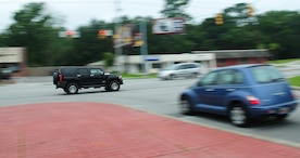 A vehicle races along the roadway just outside the Dorchester Road main gate here June 17. According to base security forces, motorists are reminded to remain prepared every day while traveling the streets and highways. The majority of traffic violations are speeding, not using a seatbelt, running stop signs and improper backing. (U.S. Air Force photo/Staff Sgt. Daniel Bowles)