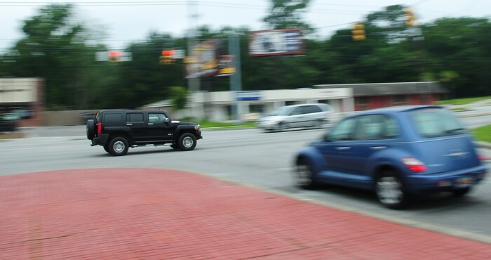 A vehicle races along the roadway just outside the Dorchester Road main gate here June 17. According to base security forces, motorists are reminded to remain prepared every day while traveling the streets and highways. The majority of traffic violations are speeding, not using a seatbelt, running stop signs and improper backing. (U.S. Air Force photo/Staff Sgt. Daniel Bowles)