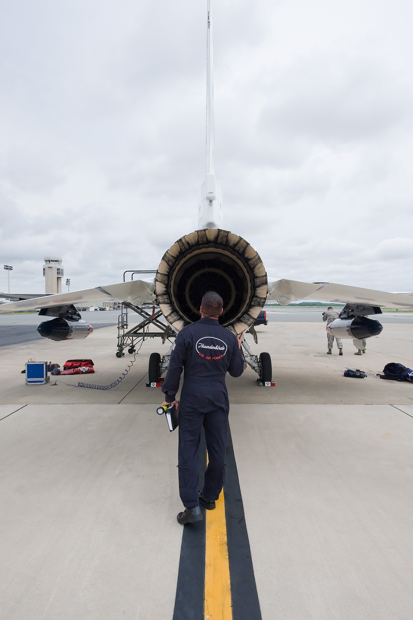 Tech. Sgt. Matthew Inman checks the engine of Thunderbird #8 at Dover Air Force Base June 17. Maj. Tony Mulhare, Thunderbird Advance Pilot and Narrator, flew the first F-16 of the Air Force’s premier Aerial Demonstration Squadron to prepare for the Dover Air Force Base Open House and Air Show June 20-21. (U.S. Air Force photo/Tom Randle)