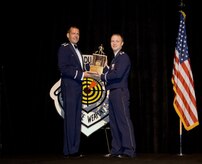 Col. Scott Kindsvater presents Capt. Christopher Stephens with one of his awards during the June 12 graduation ceremony for the Air Force Weapons School in Las Vegas, Nev. Captain Stephens was presented two awards during the graduation including an Outstanding Graduate and a Flying Award. Colonel Kindsvater is the Weapons School commandant and Captain Stephens is a pilot with the 14th Airlift Squadron. (Courtesy photo)