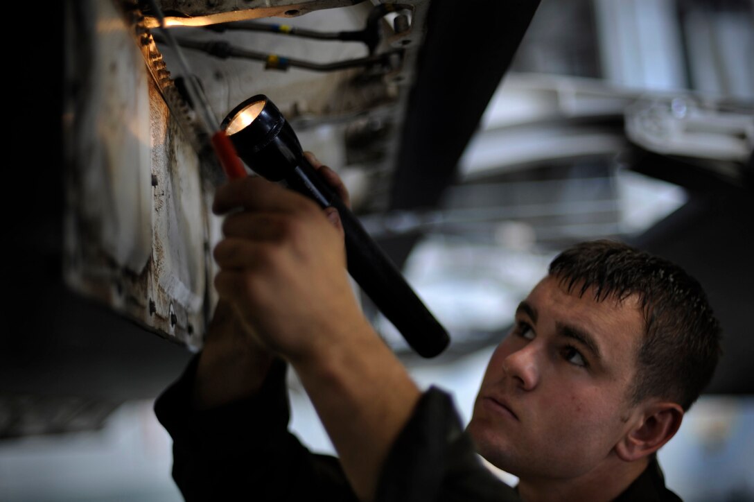 Airman 1st Class Anthony Chipman, 28th Aircraft Maintenance Squadron crew chief, performs an isochronal inspection on the right wing of a B-1B Lancer here, June 16. Airman Chipman is checking the wing for cracks, corrosion, and miscellaneous foreign object debris. (U.S. Air Force photo by Airman 1st Class Corey Hook)