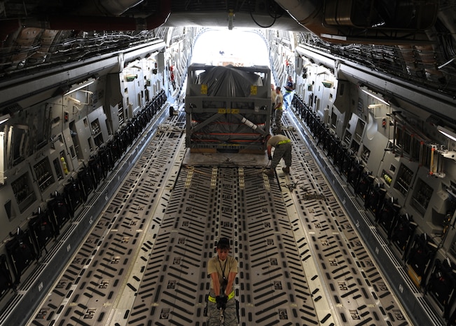 Tech. Sgt. Patricia McClure helps secure a magnetic resonance imaging machine on a C-17 bound for Salta, Argentina, June 17. In Argentina, the equipment will be used for general medical use as well as medical research. Sergeant McClure is an air transportation supervisor with the 437th Aerial Port Squadron. (U.S. Air Force photo/Senior Airman Katie Gieratz)