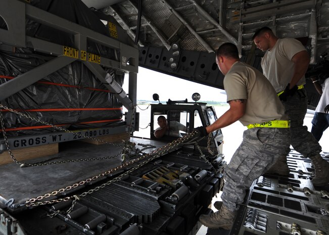 Airmen load a magnetic resonance imaging machine onto a C-17 bound for Salta, Argentina, June 17.  The Air Force and the Denton Program have helped make the movement of the large, high-tech, piece of medical equipment possible.  The Airmen are members of a load team with 437th Aerial Port Squadron. (U.S. Air Force photo/Senior Airman Katie Gieratz)
