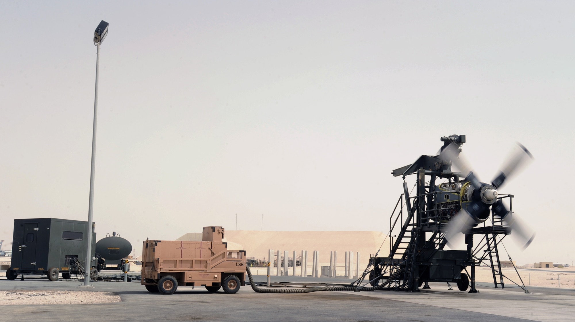 Maintainers in the 379th Expeditionary Maintenance Squadron propulsion flight at an air base in Southwest Asia run a serviceability test on a C-130H Hercules engine June 14 using the new T56 engine test cell.  This is the only T56 test cell in the U.S. Central Command area of responsibility and enables maintainers to test engines in the AOR instead of sending them back to Ramstein Air Base, Germany.  (U.S. Air Force photo/Staff Sgt. Joshua Garcia)