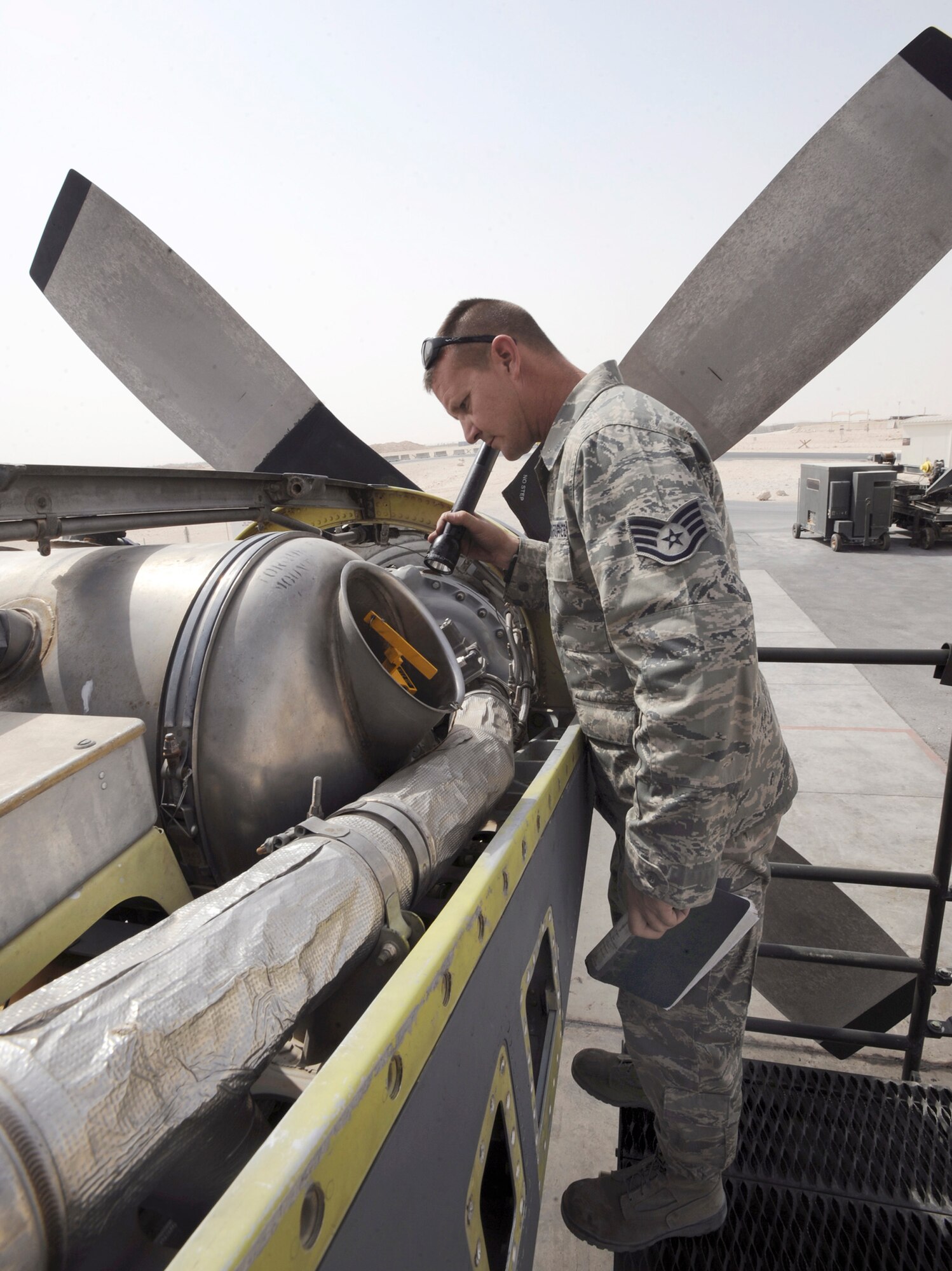 Tech. Sgt. Richard Replinger, a turbo propulsion craftsman with the 379th Expeditionary Maintenance Squadron at an air base in Southwest Asia, performs a pre-run inspection on a C-130H Hercules engine June 14 prior to running a test on the engine.  This is the only T56 test cell in the U.S. Central Command area of responsibility.  The T56 enables maintainers to test engines in the AOR instead of sending them back to Ramstein Air Base, Germany.  Sergeant Replinger, a native of Fayetteville, N.C., is deployed from Hurlburt Field, Fla.  (U.S. Air Force photo/Staff Sgt. Joshua Garcia)