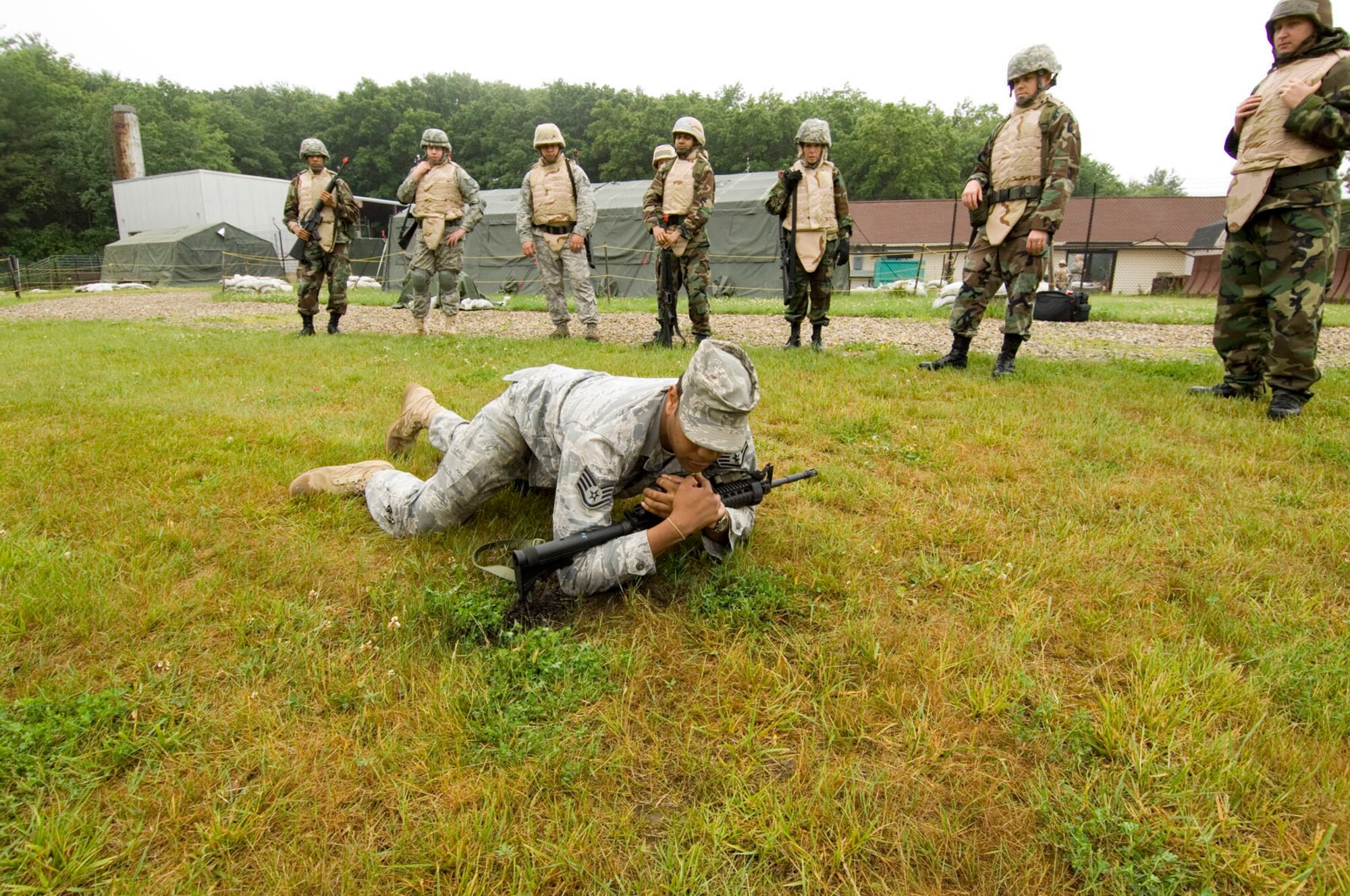 During an individual movement techniques training session, which is part of Hanscom's EACS course, Staff Sgt. Brandon Jenkins, 66th Security Forces Squadron unit trainer, demonstrates the high crawl technique for EACS students.  (U.S. Air Force photo by Rick Berry)