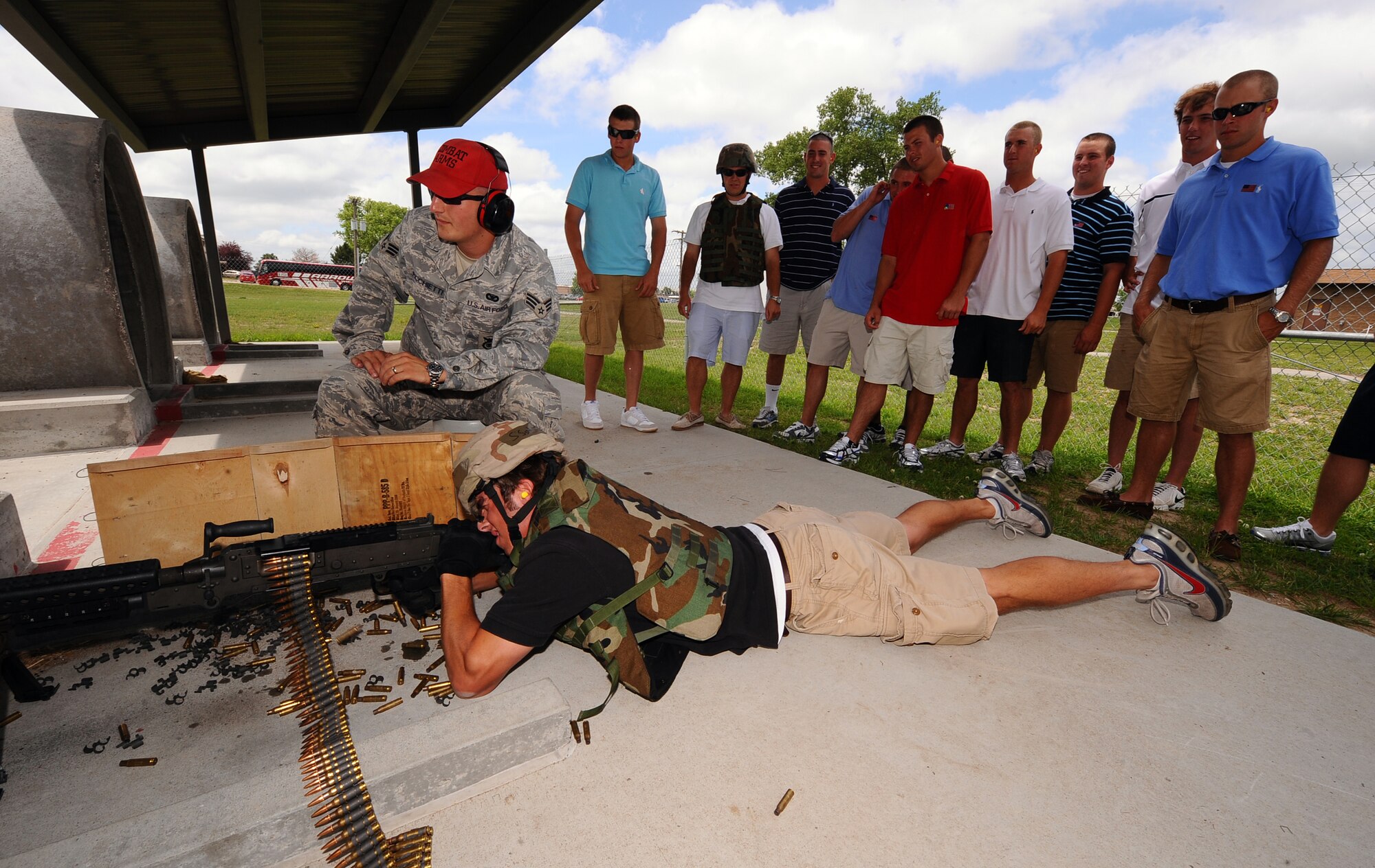 OFFUTT AIR FORCE BASE Neb.,-- Short Stop Ryan Graepel, University of North Carolina Baseball, fires a M-240 machine gun with guidance from SrA Stephano Picchietti, 55th Security Forces Squadron,  as part of a base tour where members of the Tar heels got an inside look at the mission of the 55th Wing, 15 June.  The Tar Heels baseball team is competing in the NCAA College World Series hosted at Omaha's Rosenblatt Stadium June 13-23/24.

U.S. Air Force Photo by Josh Plueger