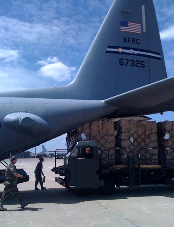 Members of the 185th Air Mobility Wing begin loading four crates of children's wheelchairs onto a C-130 June 11, 2009, in Sioux City, Iowa. A C-130 aircrew from Air Force Reserve Command's 302nd Airlift Wing, Peterson Air Force Base, Colo., transported the wheelchairs to Andrews AFB, Md., where a larger cargo plane transported the wheelchairs to Baghdad, Iraq. (U.S. Air Force photo/Capt. Brian McReynolds)

