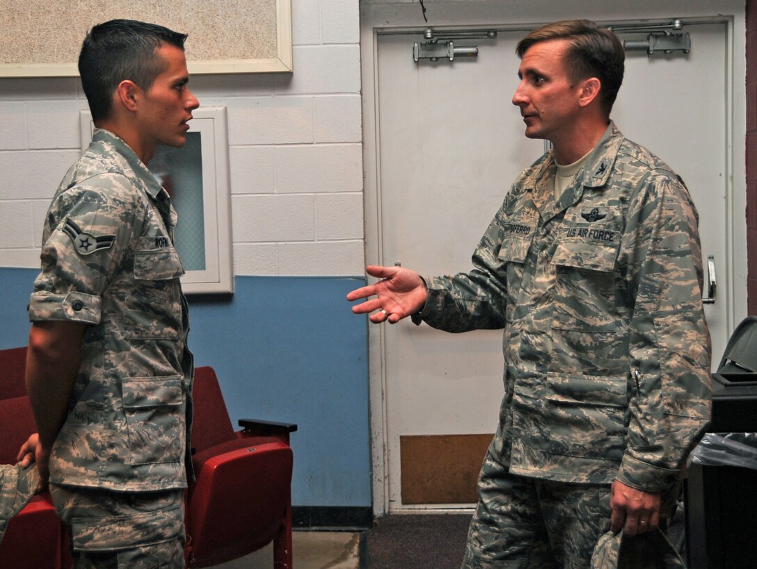 Airman 1st Class Chris Rofinot, 37th Bomb Squadron weapons load crew member, talks with Col. Jeffrey Taliaferro, 28th Bomb Wing commander, after the colonel's first commander's call here, June 16. Colonel Taliaferro discussed his vision, top priorities and expectations of the wing. (U.S. Air Force photo/Senior Airman Anthony Sanchelli)