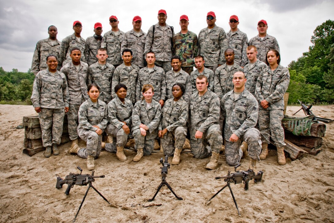 Members of the 459th Security Forces Squadron line up for a group shot on Range 21 at Fort AP Hill.  Each year, members of the 459th Security Forces Squadron are required to fire 1,100 rounds from both the M240 and M249. (U.S. Air Force Photo/ Capt. Nick Strocchia) 
