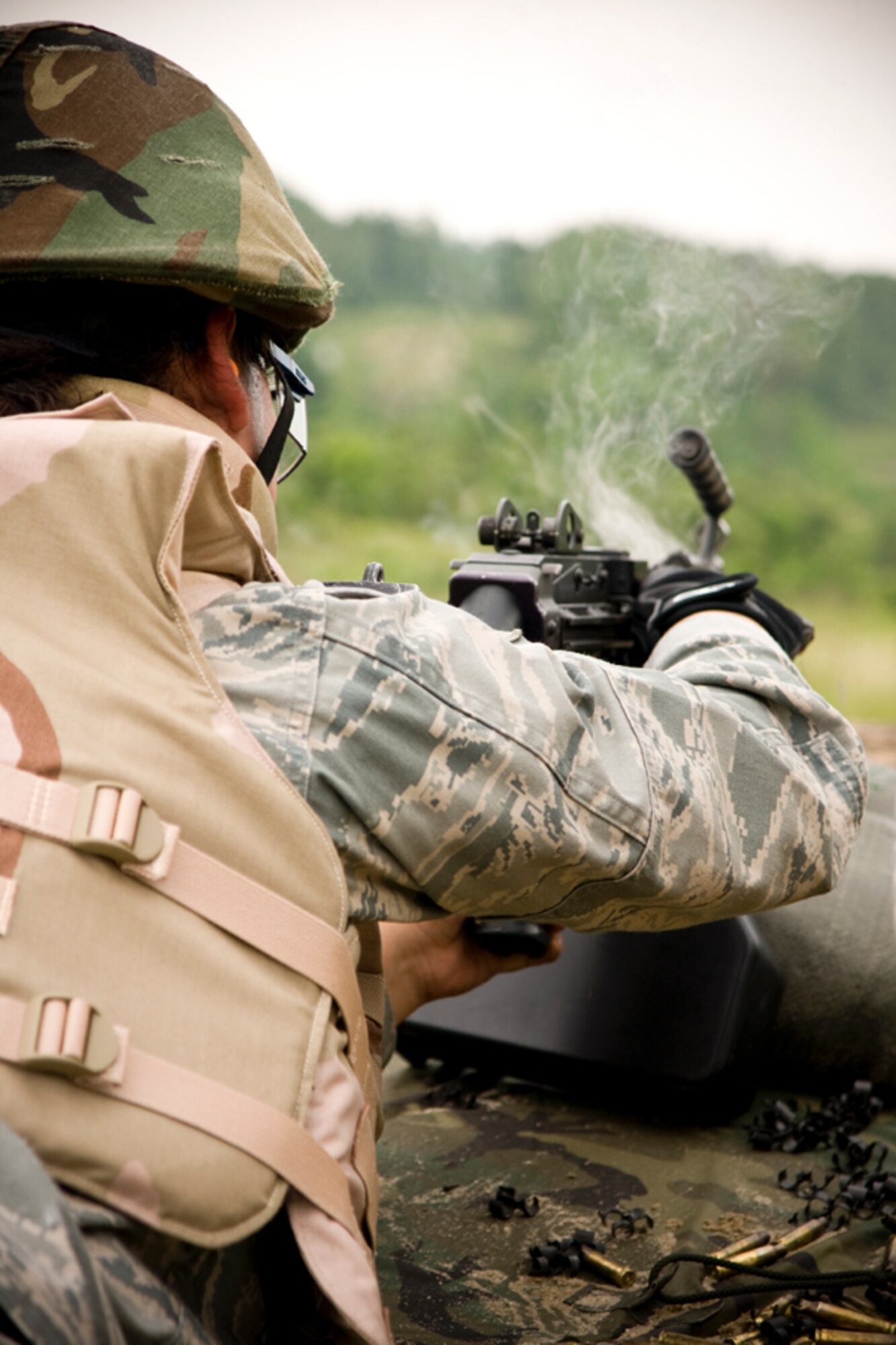 Airman Ame Perez pulls prepares to open the firing chamber on the M249 light machine gun after expending a 200 round magazine. Members of the 459th Security Forces Squadron completed their annual heavy weapons training at Fort AP Hill over the June UTA.  (U.S. Air Force Photo/ Capt. Nick Strocchia)
