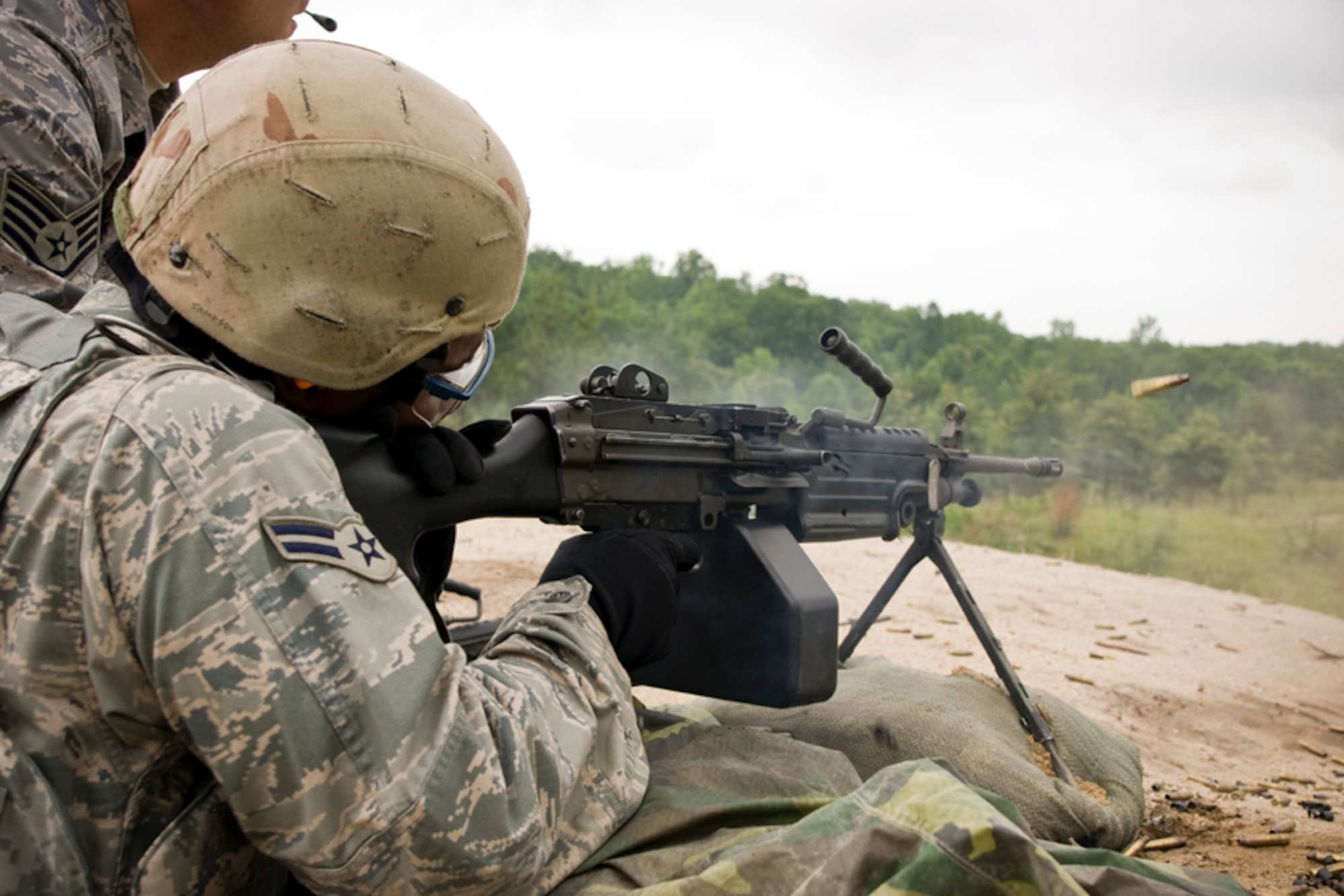 Staff Sgt. Cory Hoffman looks downrange as Airman 1st Class Martin Hawkins fires the M249.Members of the 459th Security Forces Squadron completed their annual heavy weapons training at Fort AP Hill over the June UTA. (U.S. Air Force Photo/ Capt. Nick Strocchia)
