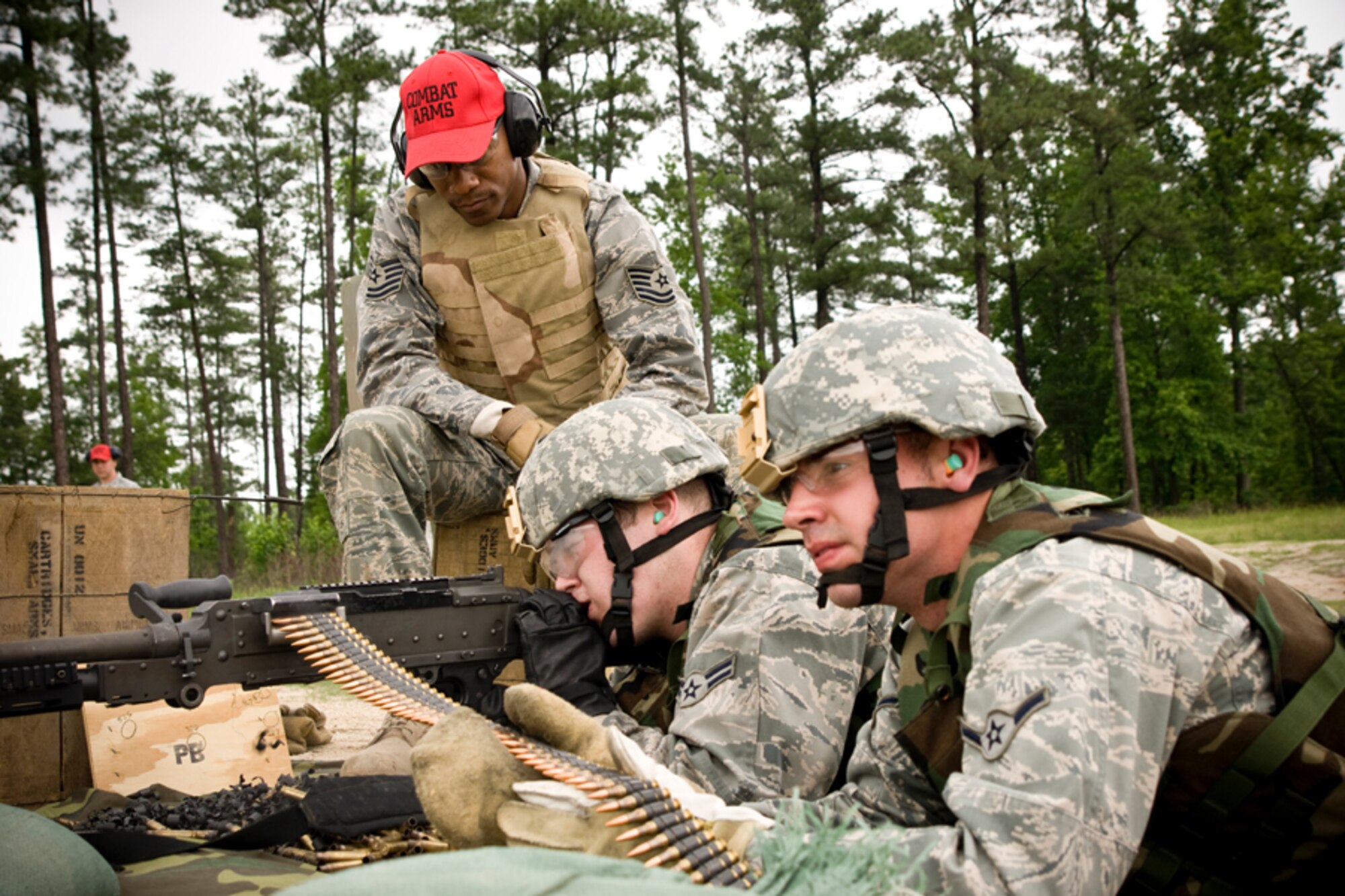 Tech Sgt. Duane Fowler looks over Airman 1st Class Franklin Holtman and Airman Andrew Landolina as the fire the M240 for the annual qualification.  Each year, members of the 459th Security Forces Squadron are required to fire 1,100 rounds from both the M240 and M249. (U.S. Air Force Photo/ Capt. Nick Strocchia)
