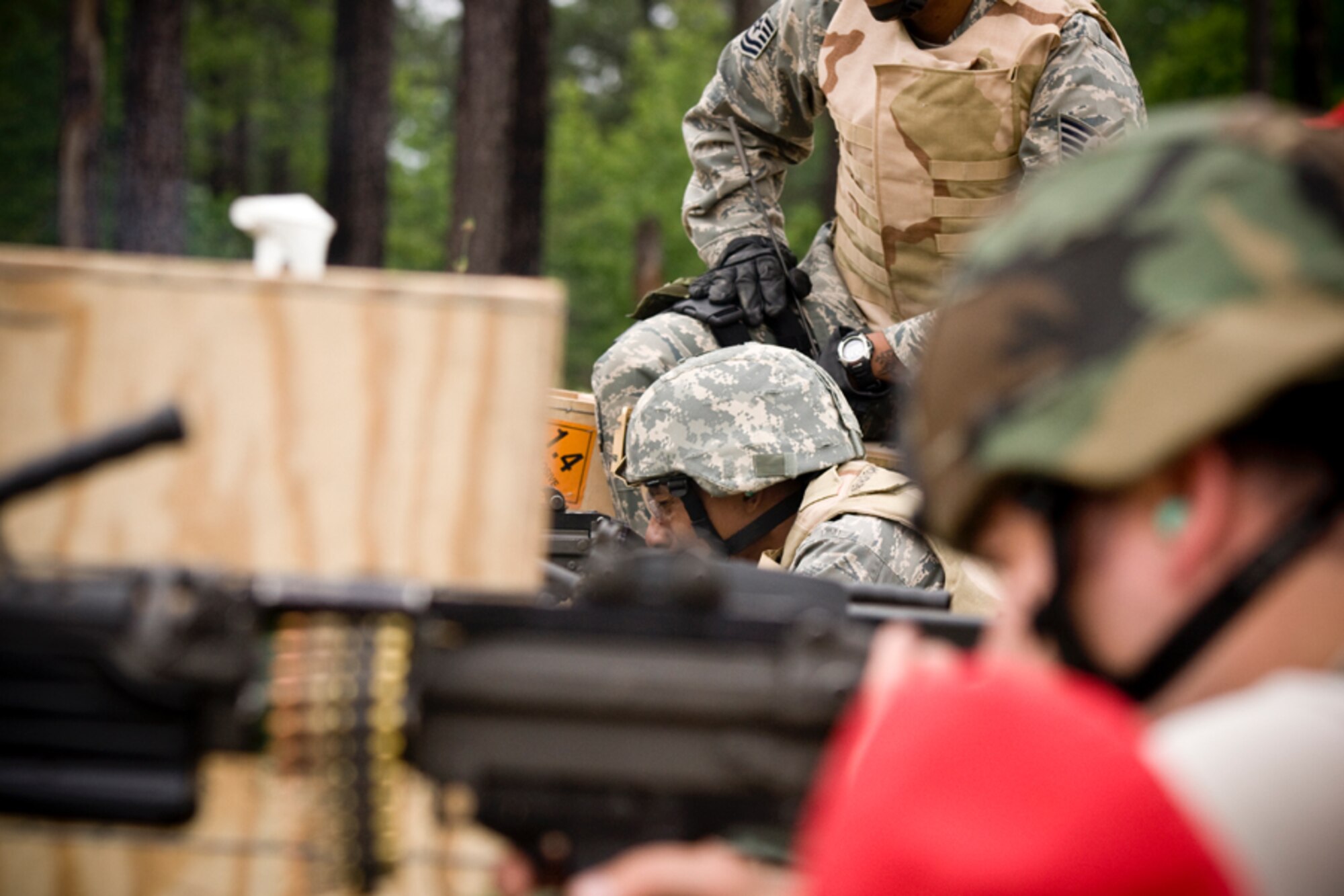 Senior Airman Kyler Lewis-Johnson fires the M240 heavy machine gun down range while Tech Sgt. Duane Fowler watches on.Members of the 459th Security Forces Squadron completed their annual heavy weapons training at Fort AP Hill over the June UTA.(U.S. Air Force Photo/ Capt. Nick Strocchia)
