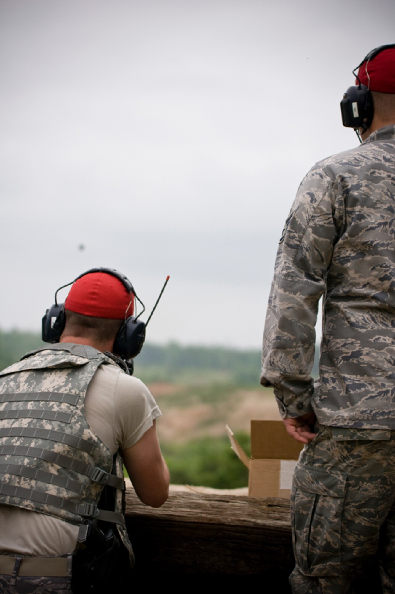 Senior Airman Ryan Matheson fires off a 40mm dummy round from the M203 grenade launcher while Staff Sgt. Matthew Barr monitors the safe ejection. (U.S. Air Force Photo/ Capt. Nick Strocchia)
