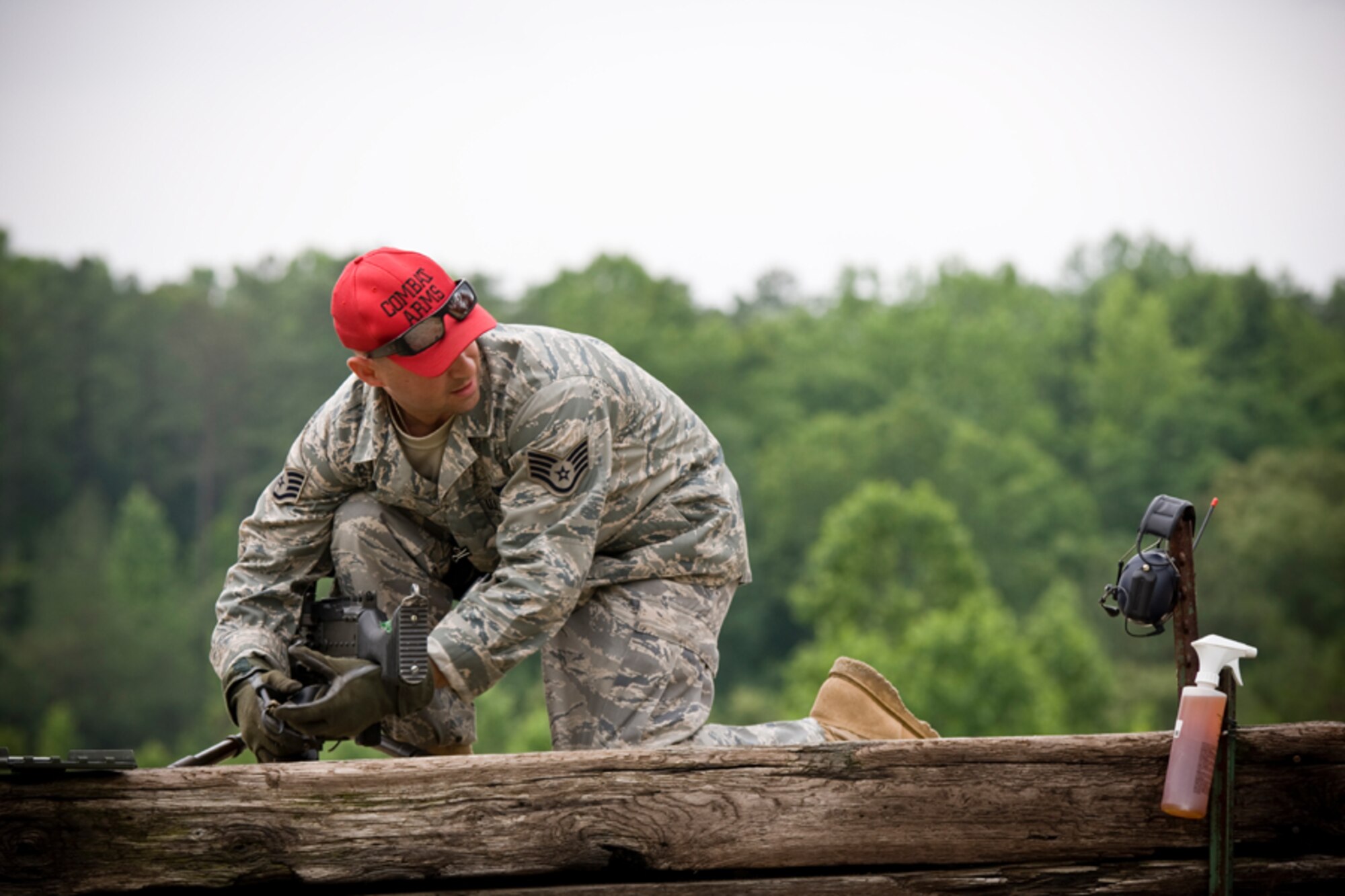 Staff Sgt. Matthew Chase prepares his M240 firing position.  This was the only firing position where a tripod mount was used.  The tripod mount provides a very stable platform for students to fire from. (U.S. Air Force Photo/ Capt. Nick Strocchia)
