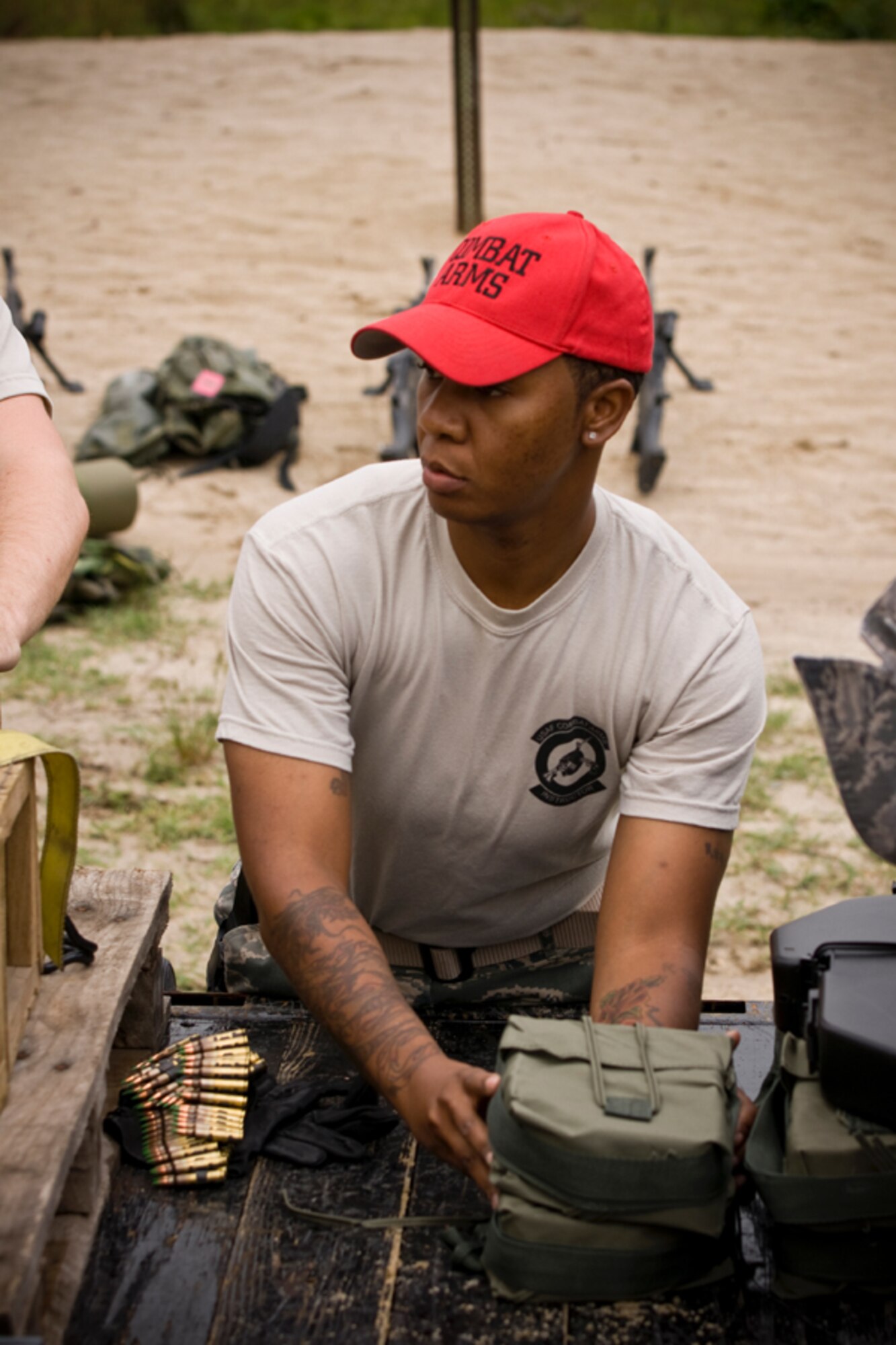 Tech Sgt. Sharese Junious offloads a 5.56mm ammo pouch which will accompany the M249 firing positions. Members of the 459th Security Forces Squadron completed their annual heavy weapons training at Fort AP Hill over the June UTA. (U.S. Air Force Photo/ Capt. Nick Strocchia)